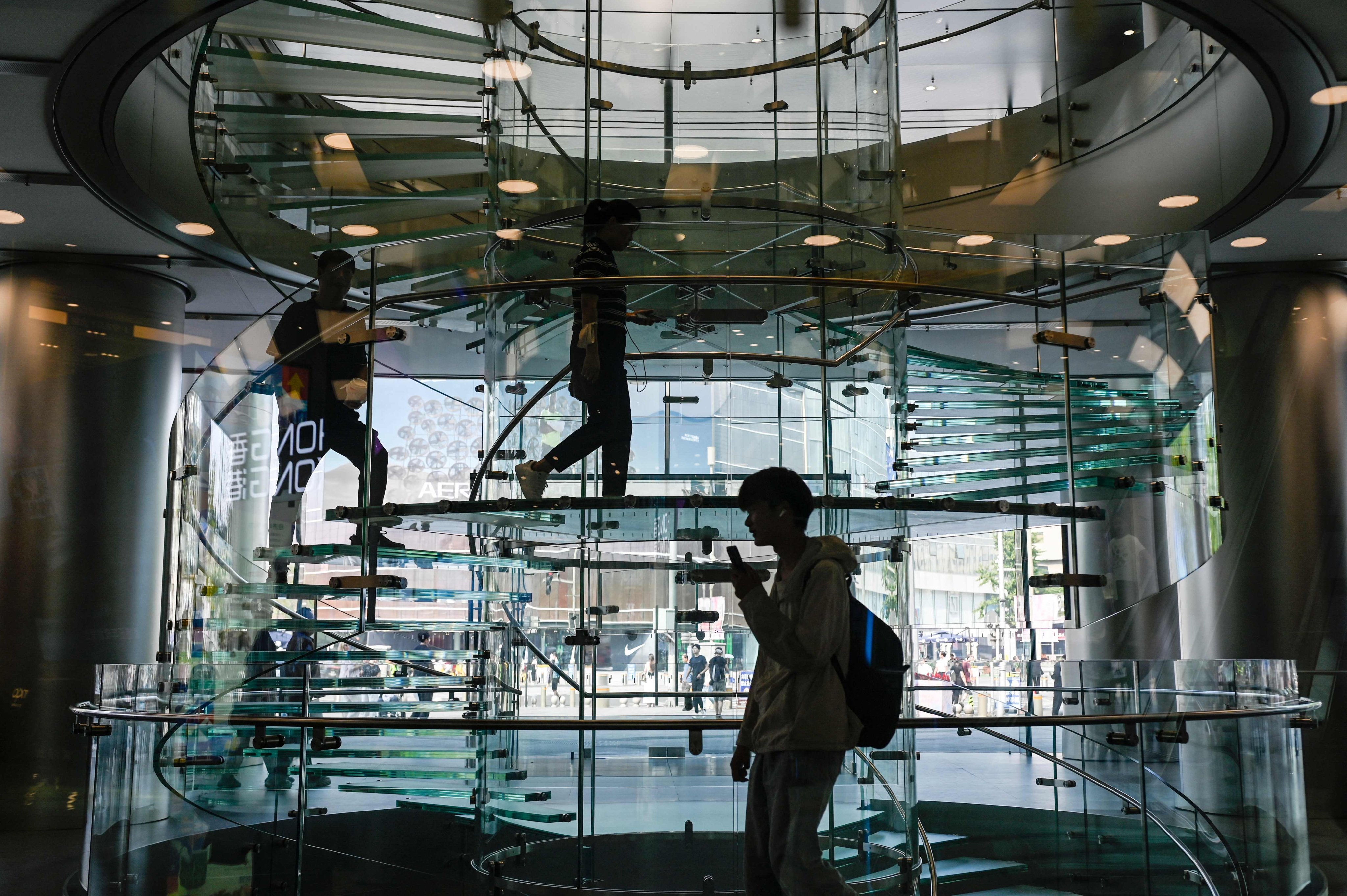 People visit an Apple store in a mall in Beijing on September 23. Photo: AFP