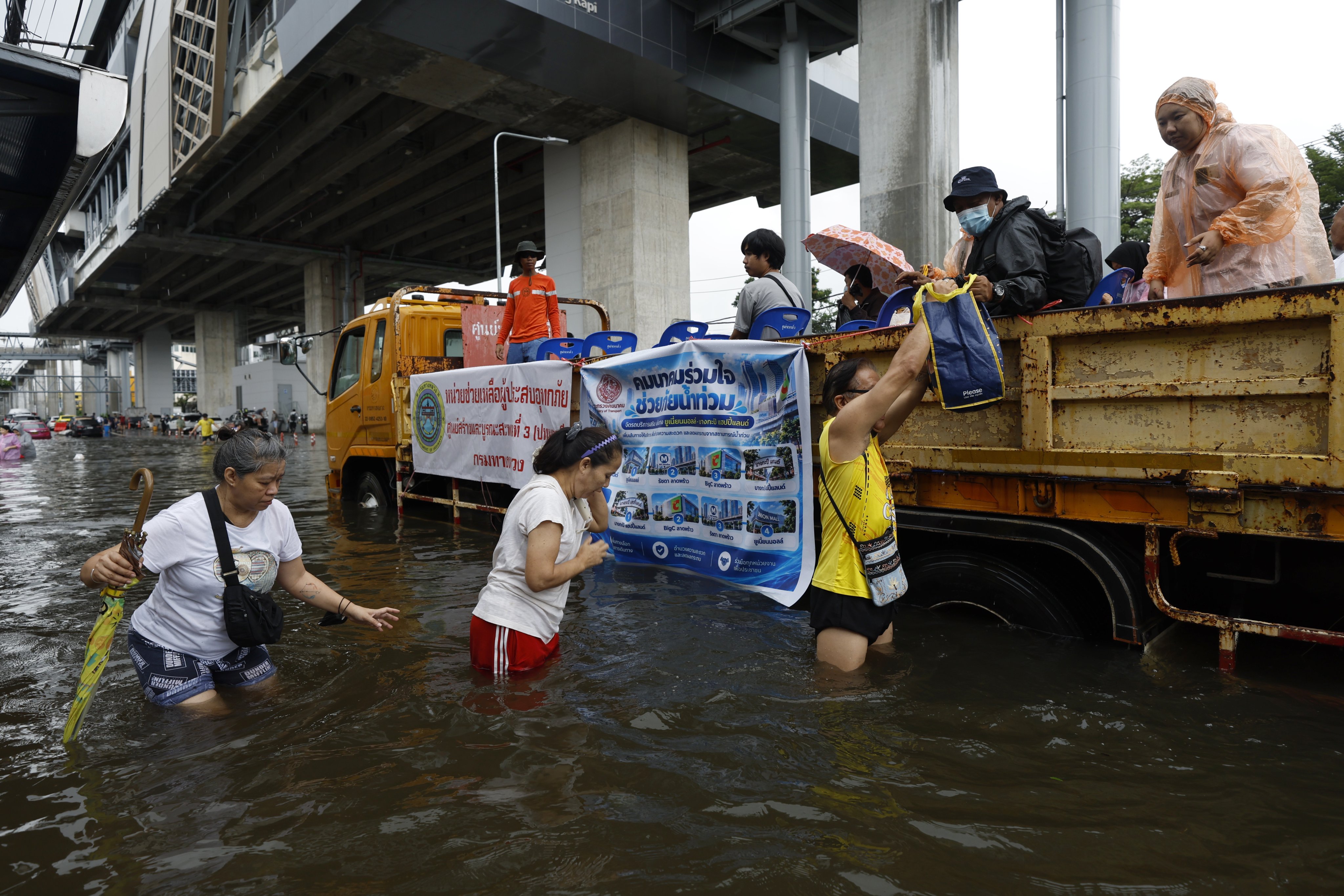 Thai residents travel on a truck on a flooded street in Bangkapi district, Bangkok, on Monday. Photo: EPA