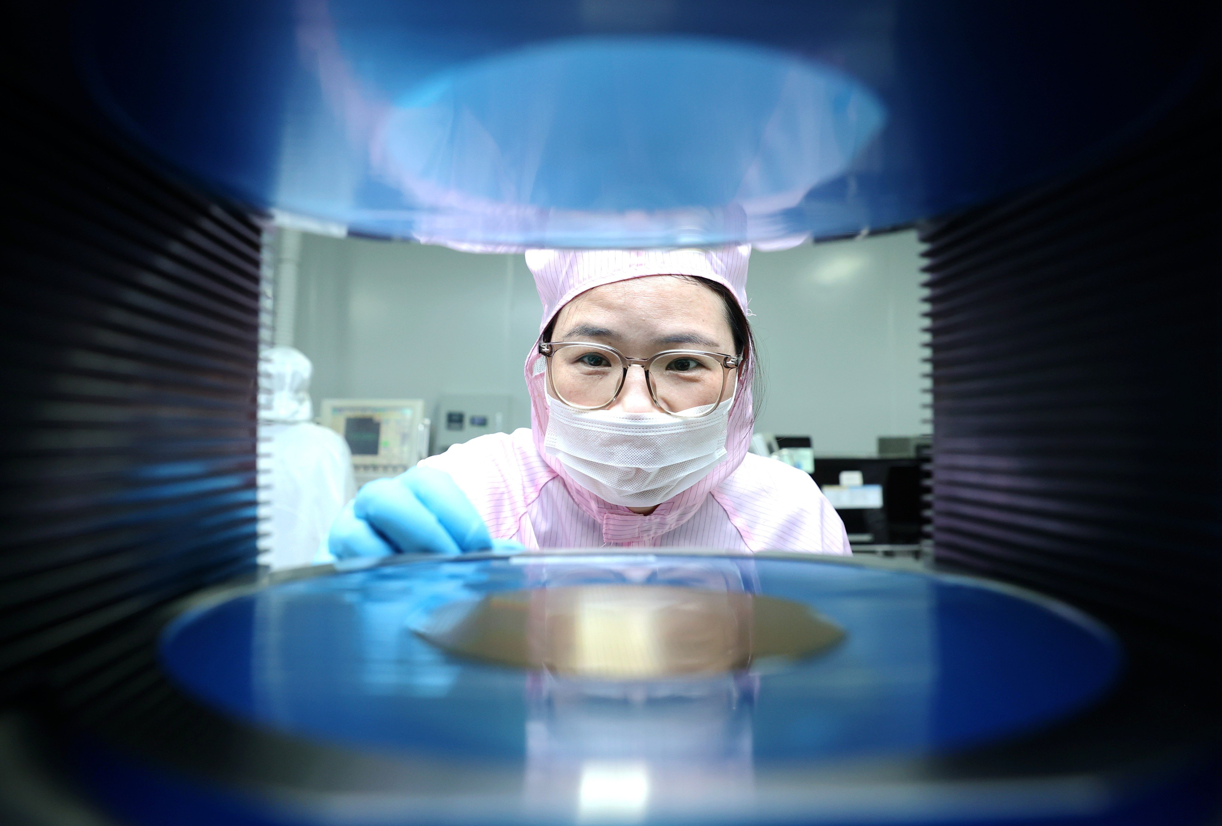 A worker operates equipment at a semiconductor firm in China's Jiangsu province on September 16. Semiconductors have become a field of intense competition between Washington and Beijing. Photo: VCG via Getty Images