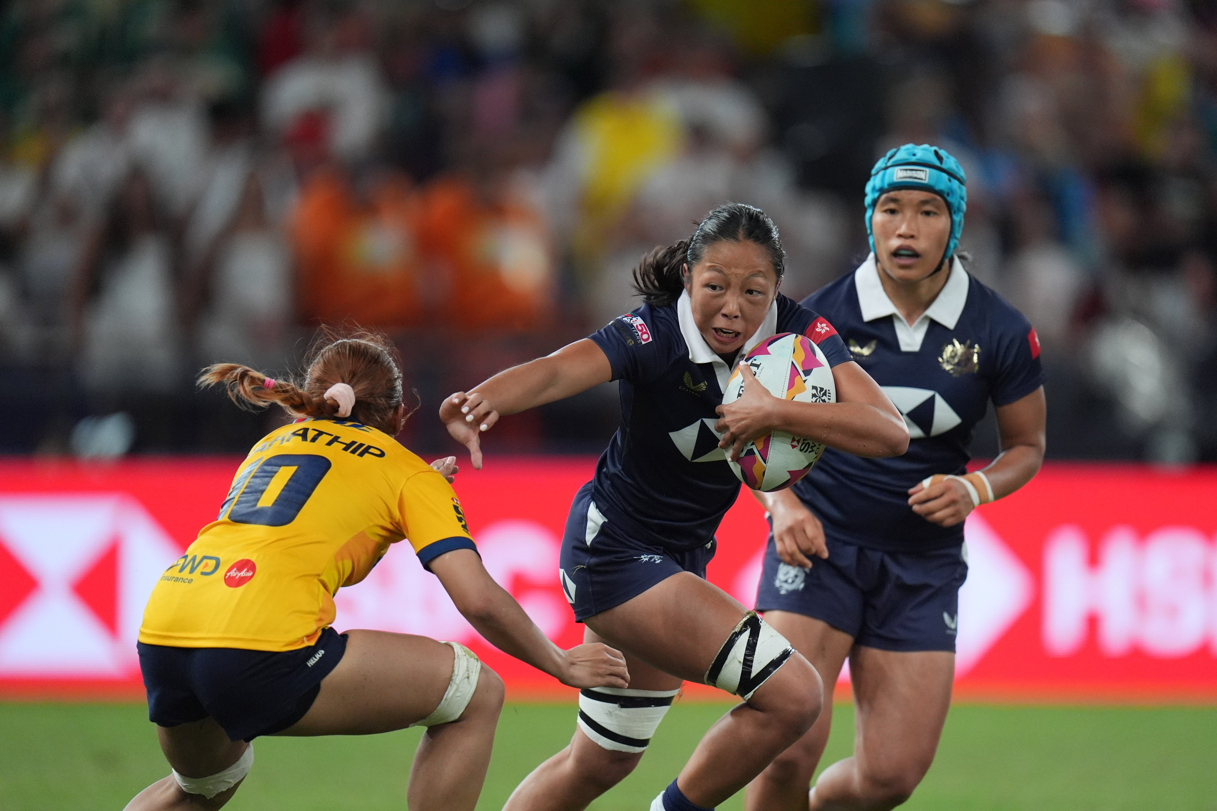 Chloe Chan fends off a Thai opponent during this year’s Cathay/HSBC Hong Kong Sevens. Photo: Elson Li