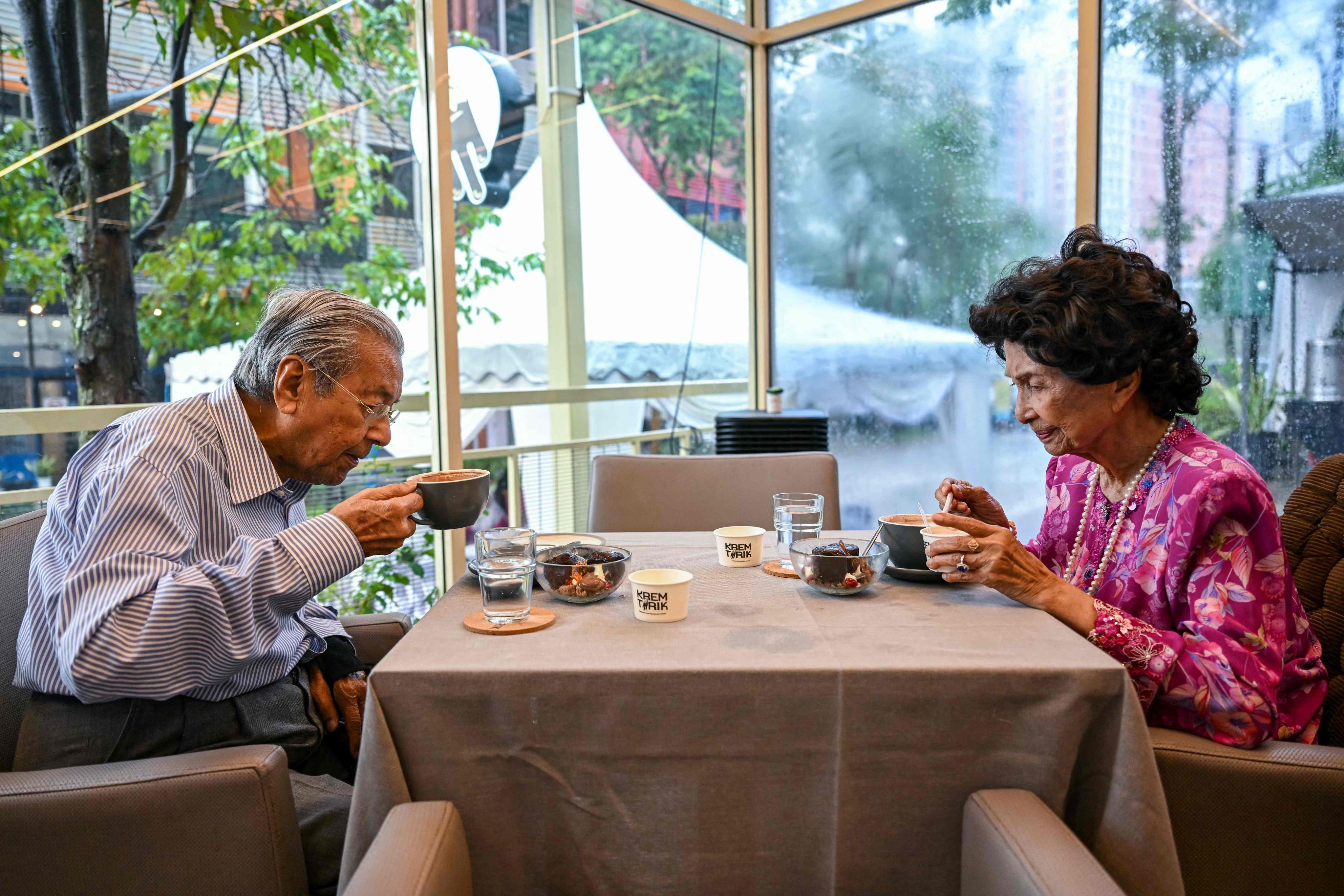 Siti Hasmah Mohamad Ali and her husband Mahathir Mohamad drink coffee in Shah Alam, on the outskirts of Kuala Lumpur, in June last year. Photo: AFP