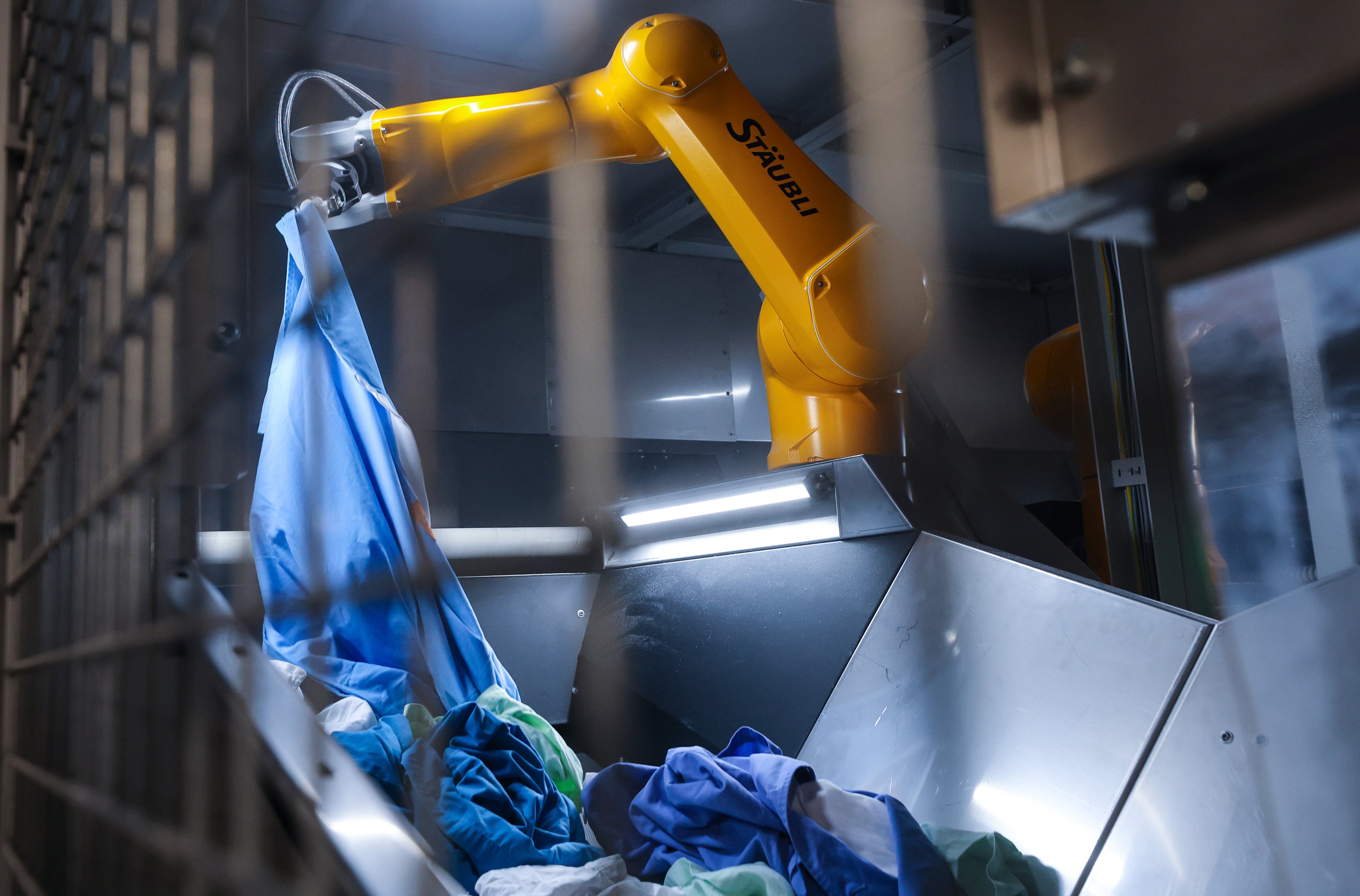 The facility meets about half of public hospitals’ laundry and meal demand, deploying X-ray sorting, robotic arms and cook-chill kitchen technology. Photo: Edmond So