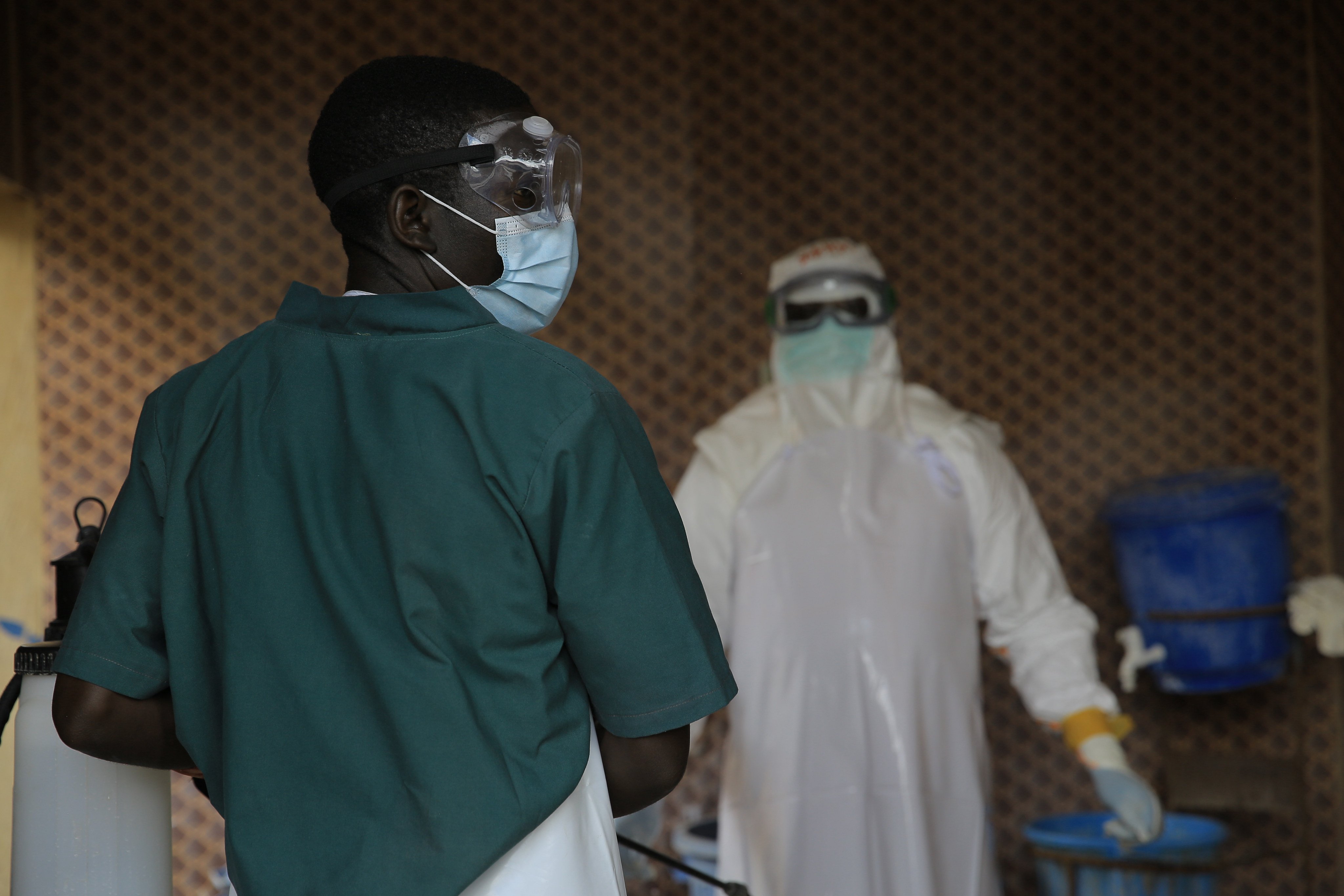 A healthcare worker is disinfected by his colleague inside a treatment centre for Ebola patients in North Kivu province in eastern Congo on Saturday. Photo: AP