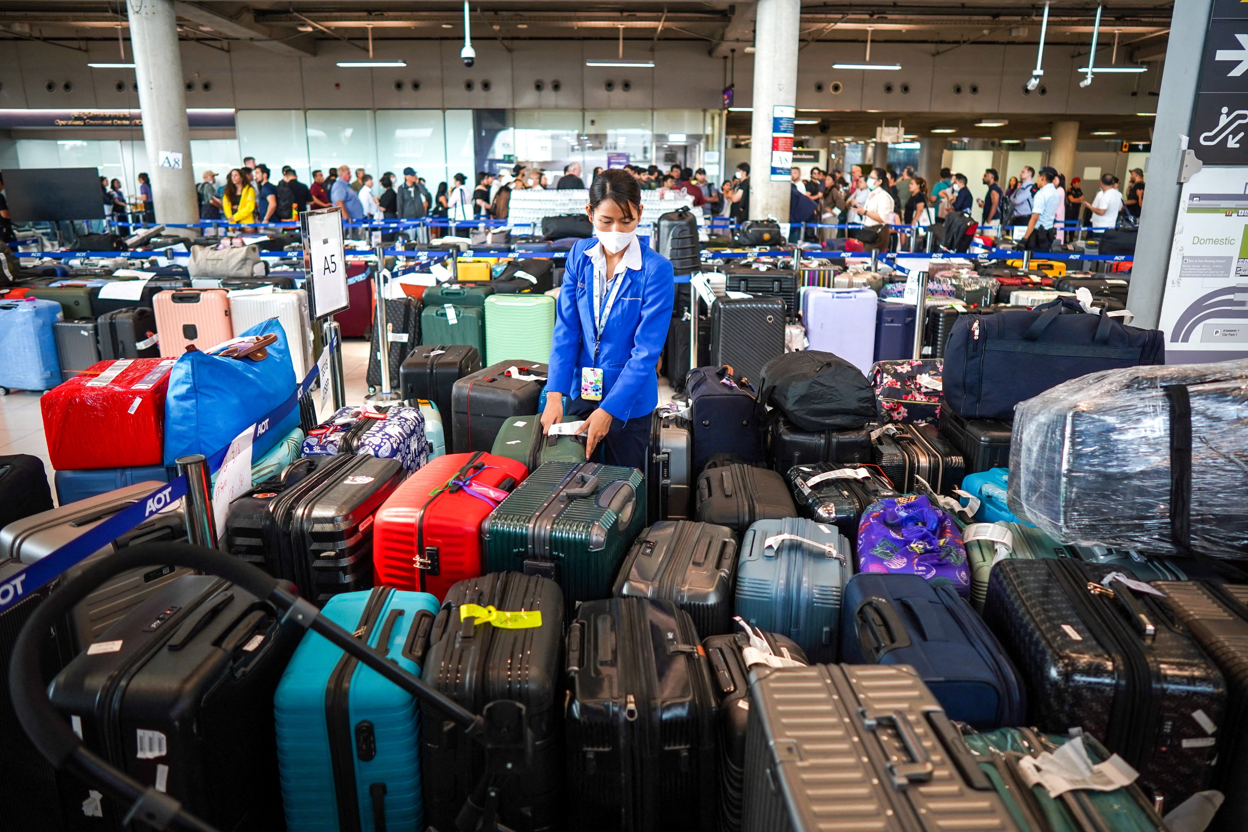 An officer arranges baggage from Thai Airways flights at Suvarnabhumi Airport in Bangkok on Tuesday. Photo: Reuters