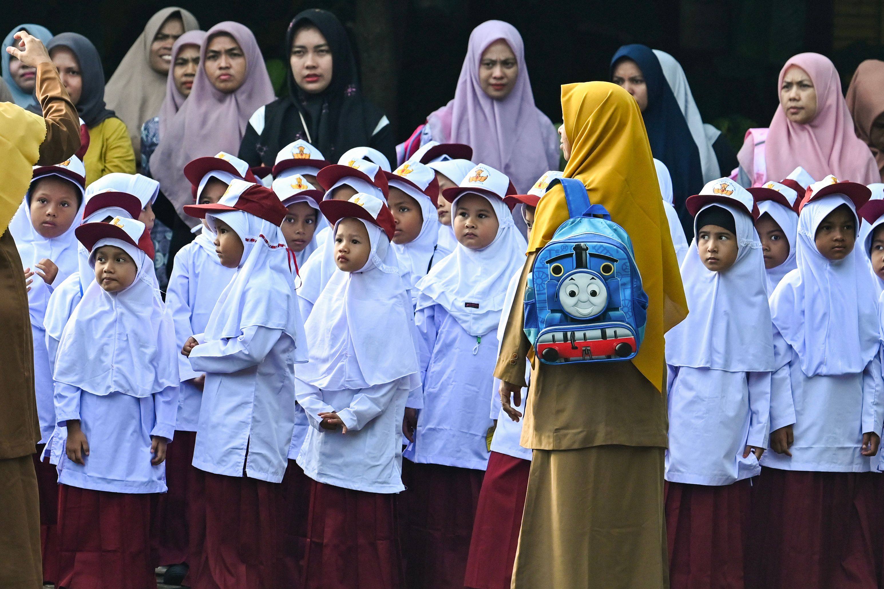 Pupils take part in a routine ceremony on the first day of school at an elementary school in Banda Aceh, Indonesia on July 15, 2024. Photo: AFP