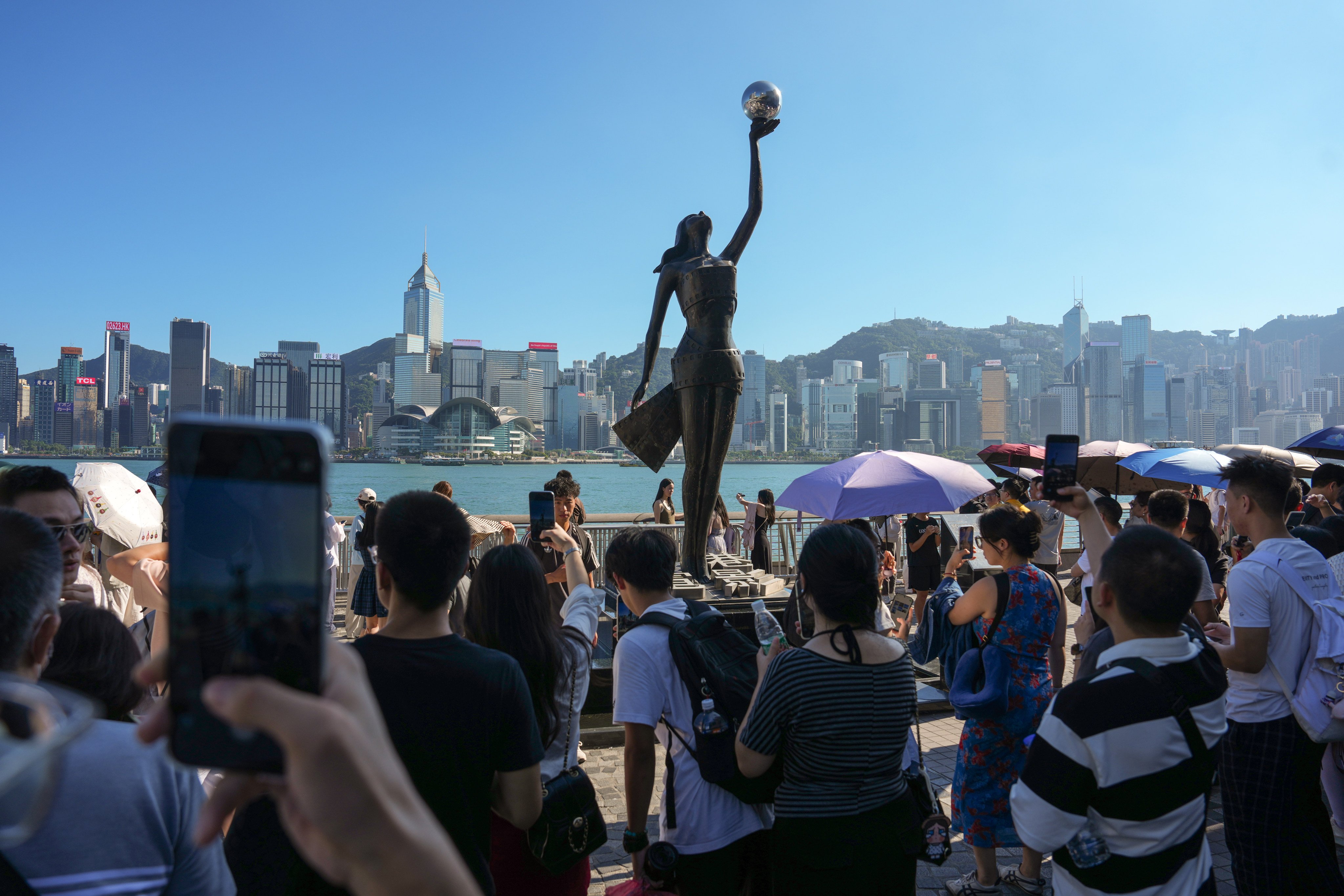 Tourists at the Victoria Harbour waterfront in Tsim Sha Tsui. Authorities expect to welcome 1.29 million visitors from across the border during the "golden week" break. Photo: Kit Lai