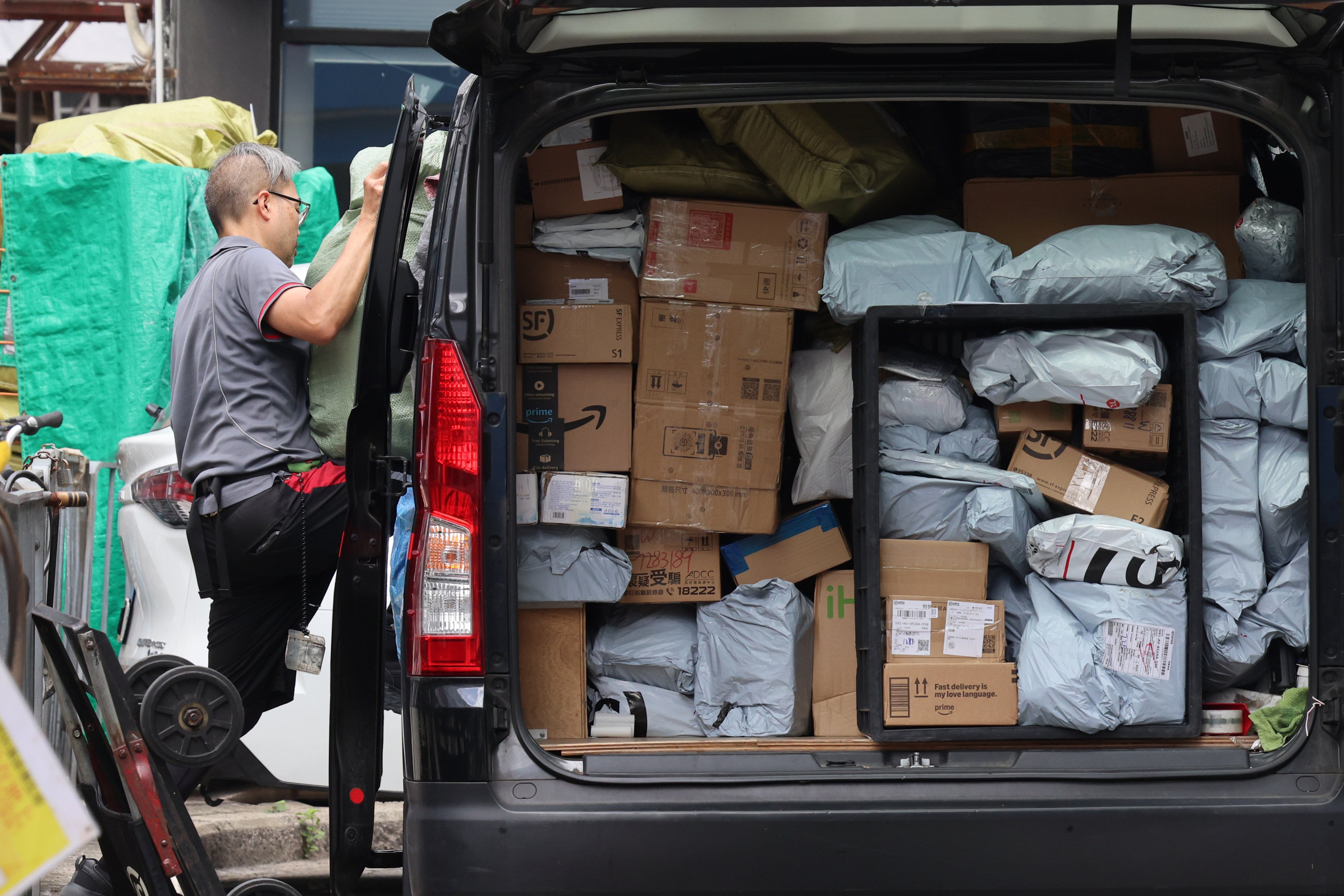 A SF Express staff handle parcels at Tai Po Market. Photo: Jelly Tse