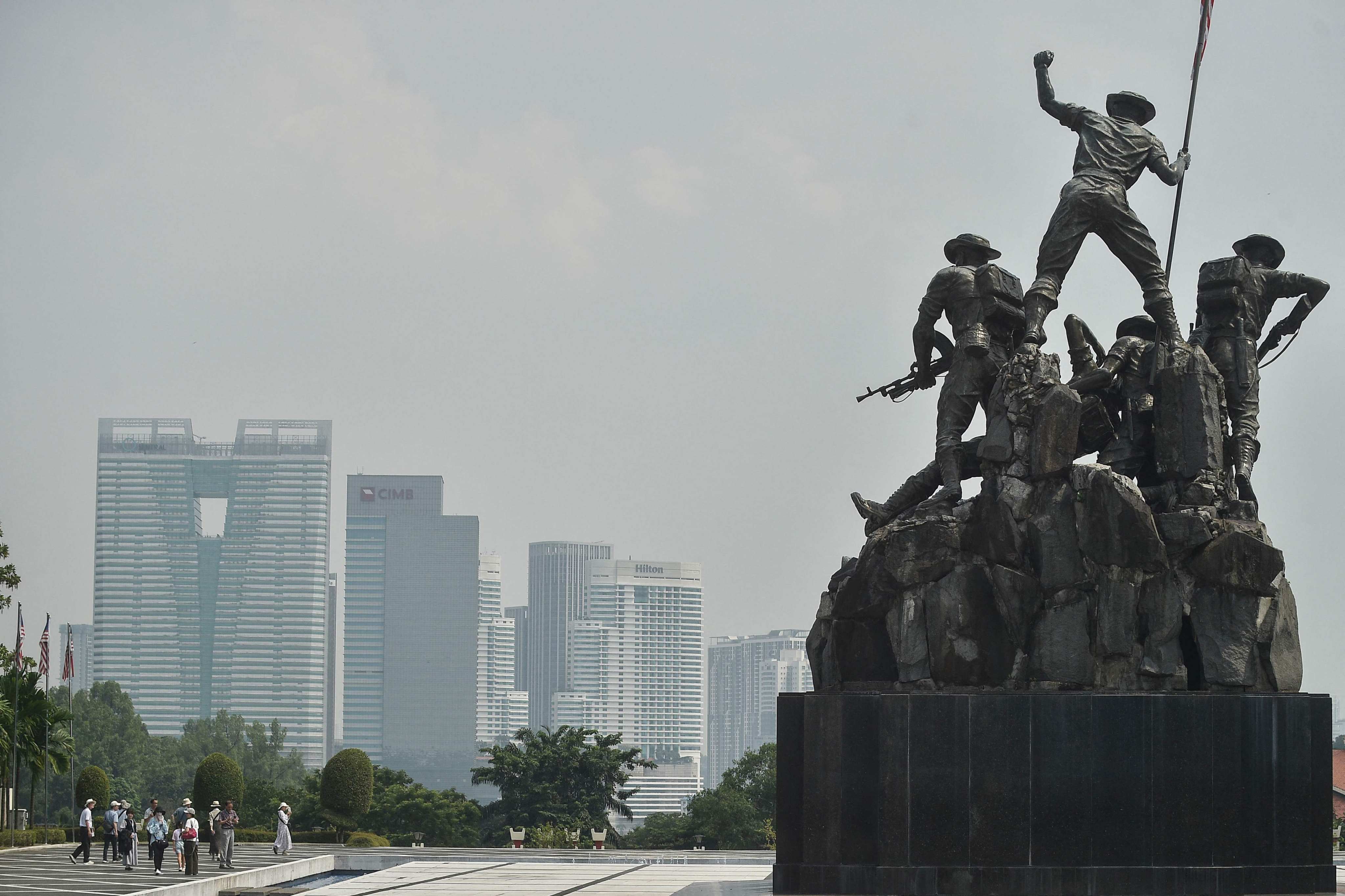 Buildings in the background past the National Monument seen shrouded by haze in Kuala Lumpur on September 21. Photo: AFP