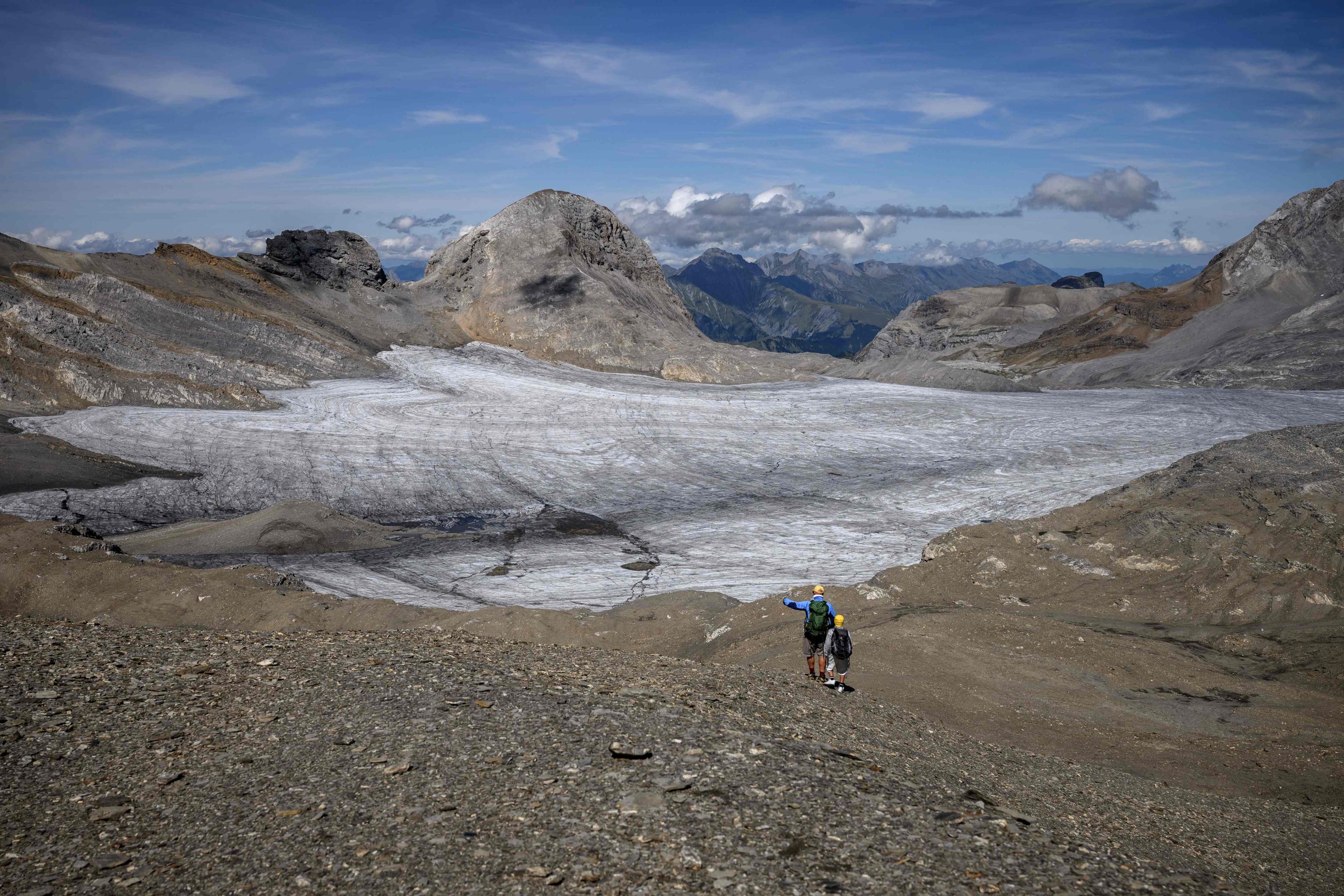 A father and his son look at the melting Plaine Morte Glacier. Photo: AFP