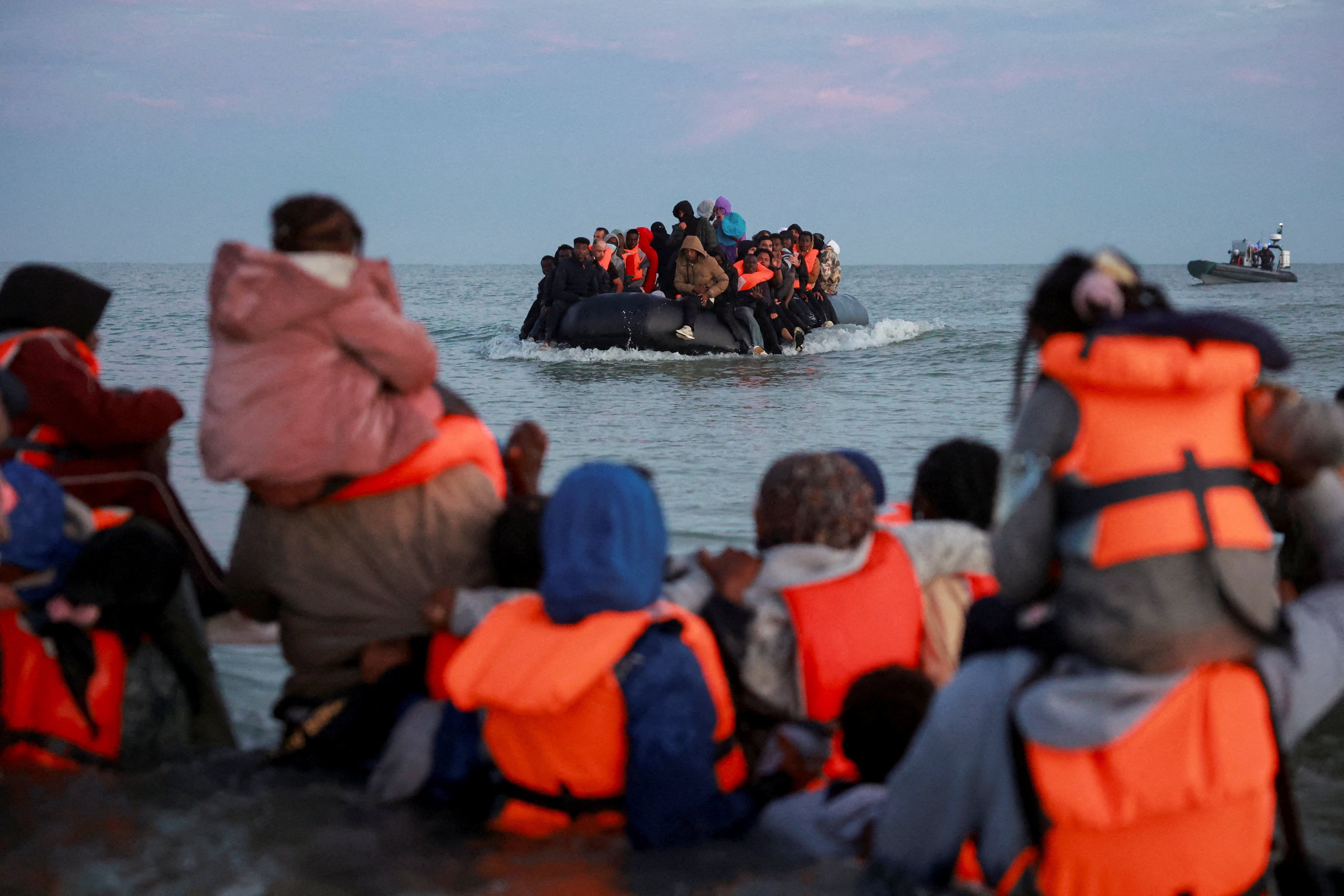 Migrants in life jackets prepare to cross the English Channel off the coast of northern France. Photo: Reuters