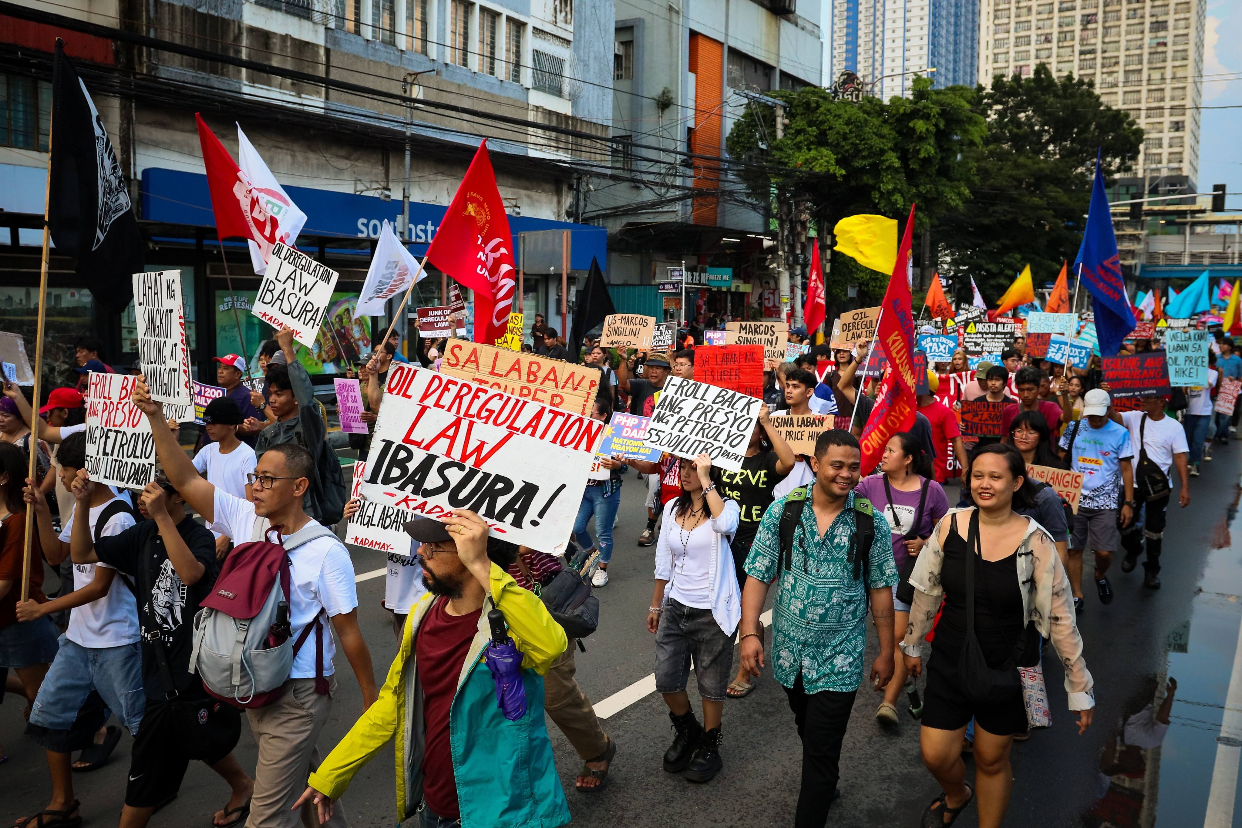Jeepney drivers, transport workers and supporters rally through Metro Manila during a transport strike over rising fuel prices and operating costs on Wednesday. Photo: dpa