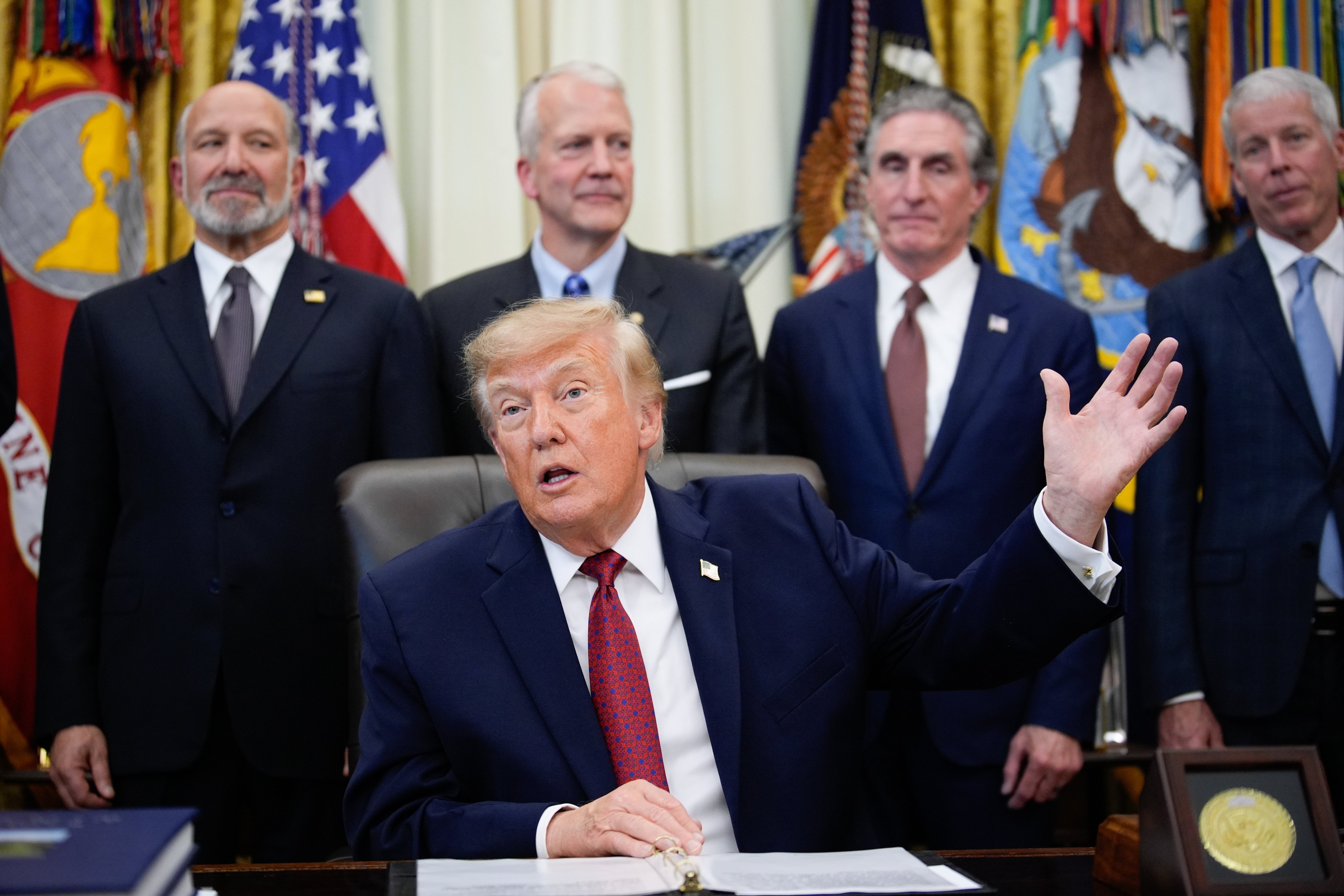 US President Donald Trump (seated) is accompanied by politicians and energy executives during his announcement of South Korean investments on Wednesday. Photo: EPA