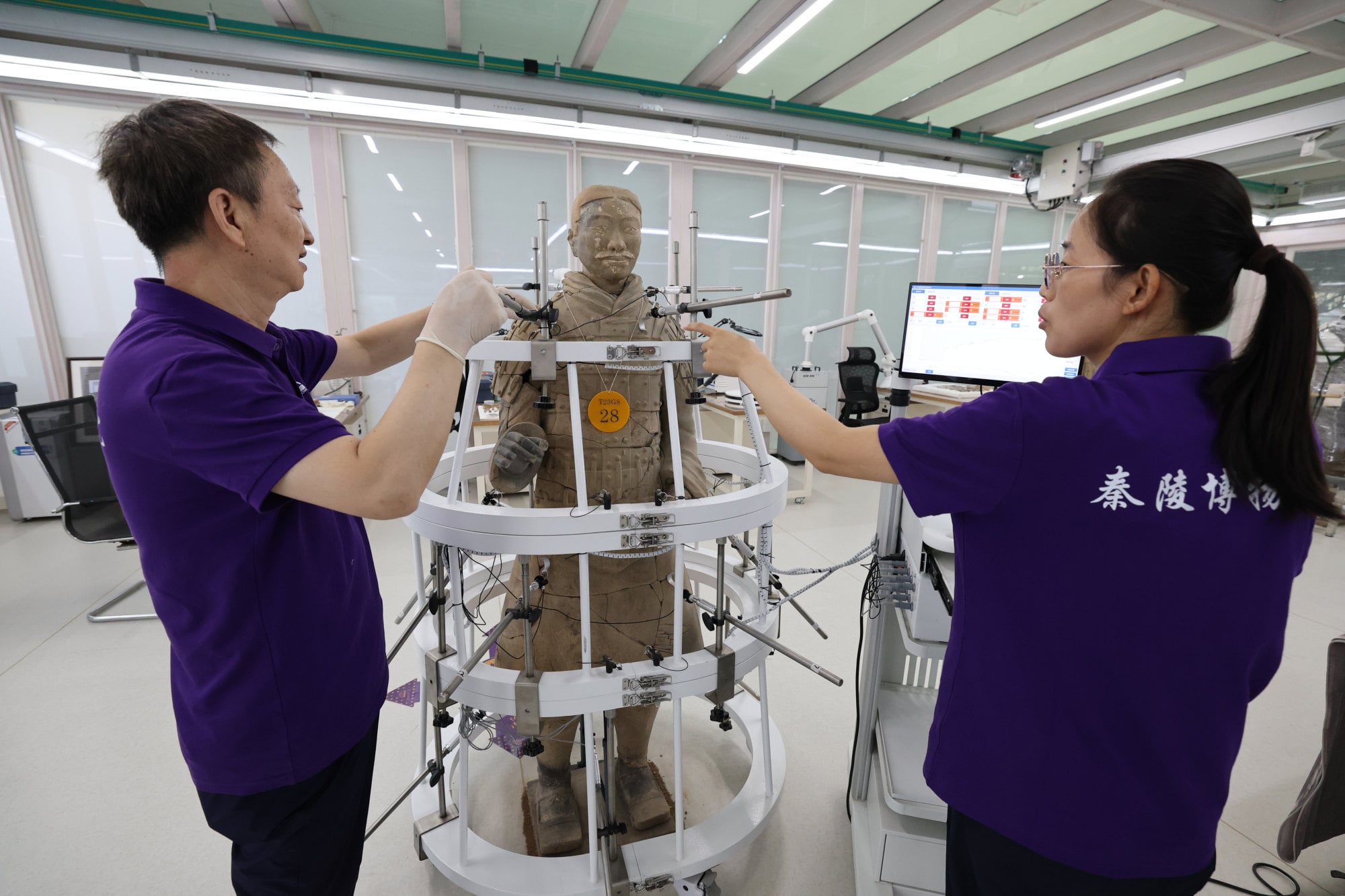 Researchers at the Emperor Qinshihuang’s Mausoleum Site Museum, in China’s Shaanxi province, work on a terracotta warrior on September 9. Photo: Xinhua
