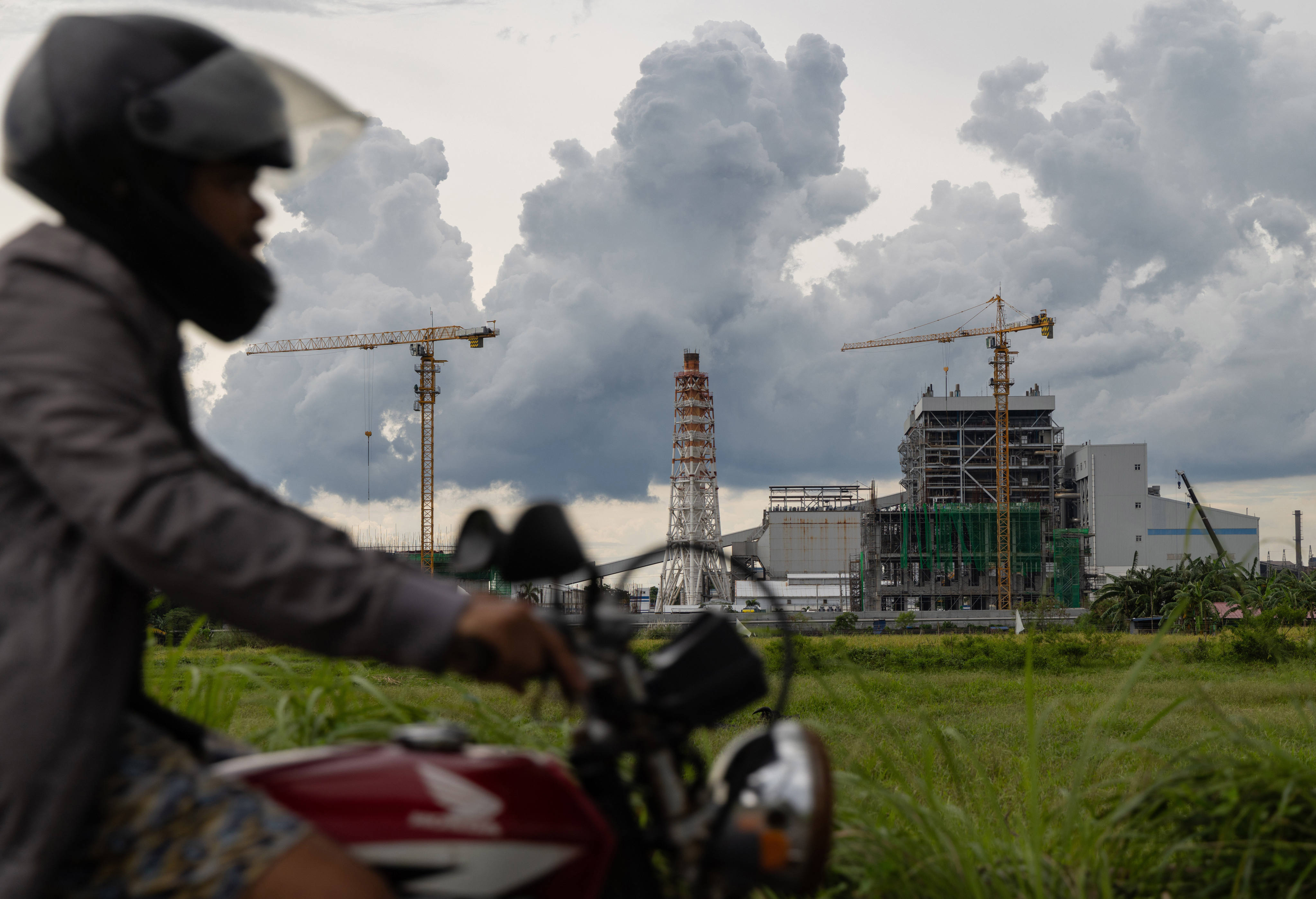 A motorcyclist drives past the South Luzon Thermal Energy Power Plant in Calaca, Batangas, in the Philippines in October 2025. Photo: AP