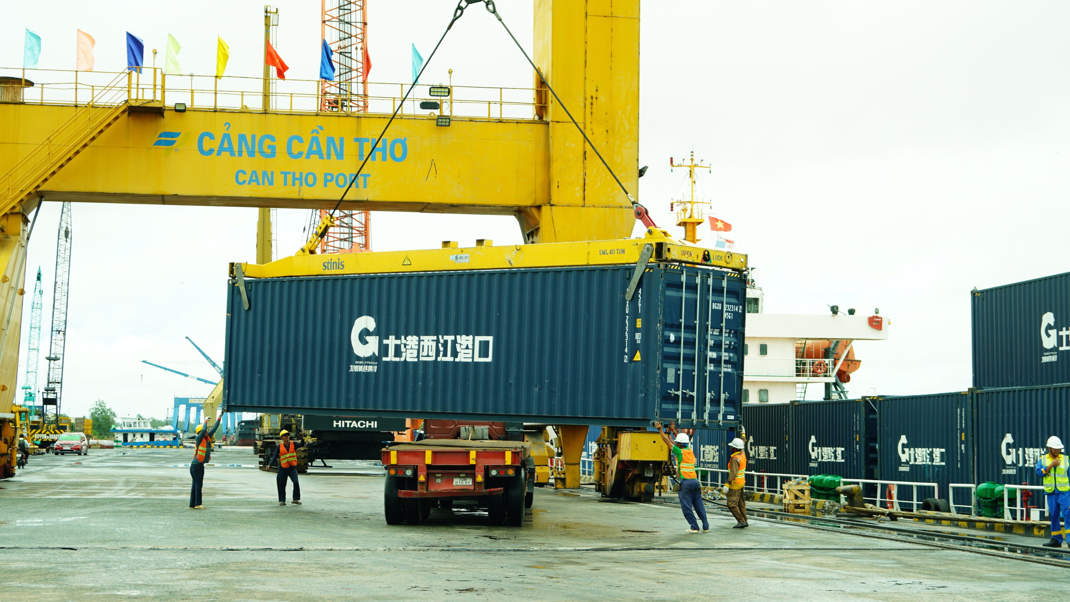 Workers unload a container from the first foreign trade vessel to sail through China’s Pinglu Canal at Can Tho Port in Vietnam on  September 24. Photo: Xinhua