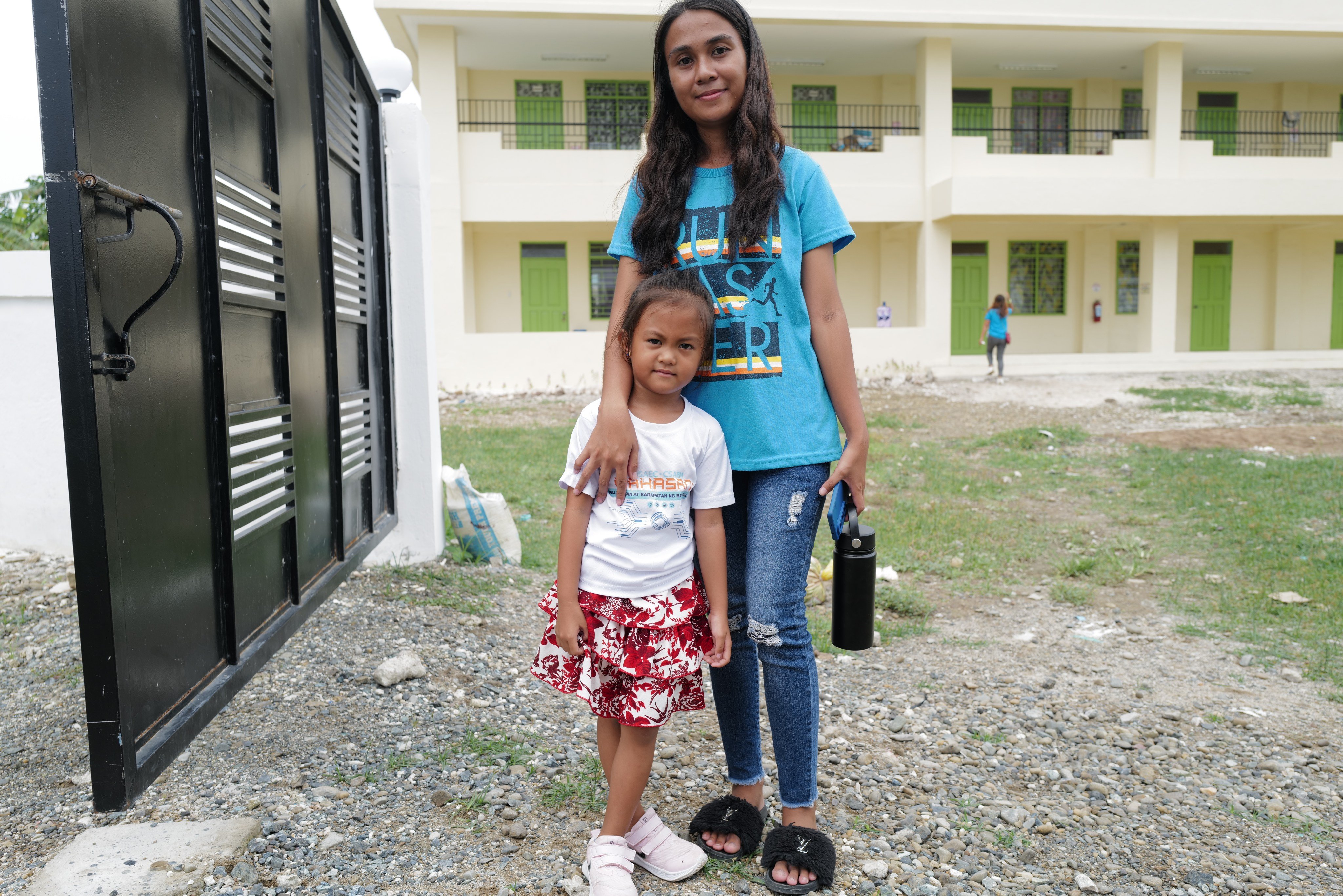 Gemelyn Amlang poses with her daughter inside a primary school in Thitu. Photo: Jeoffrey Maitem