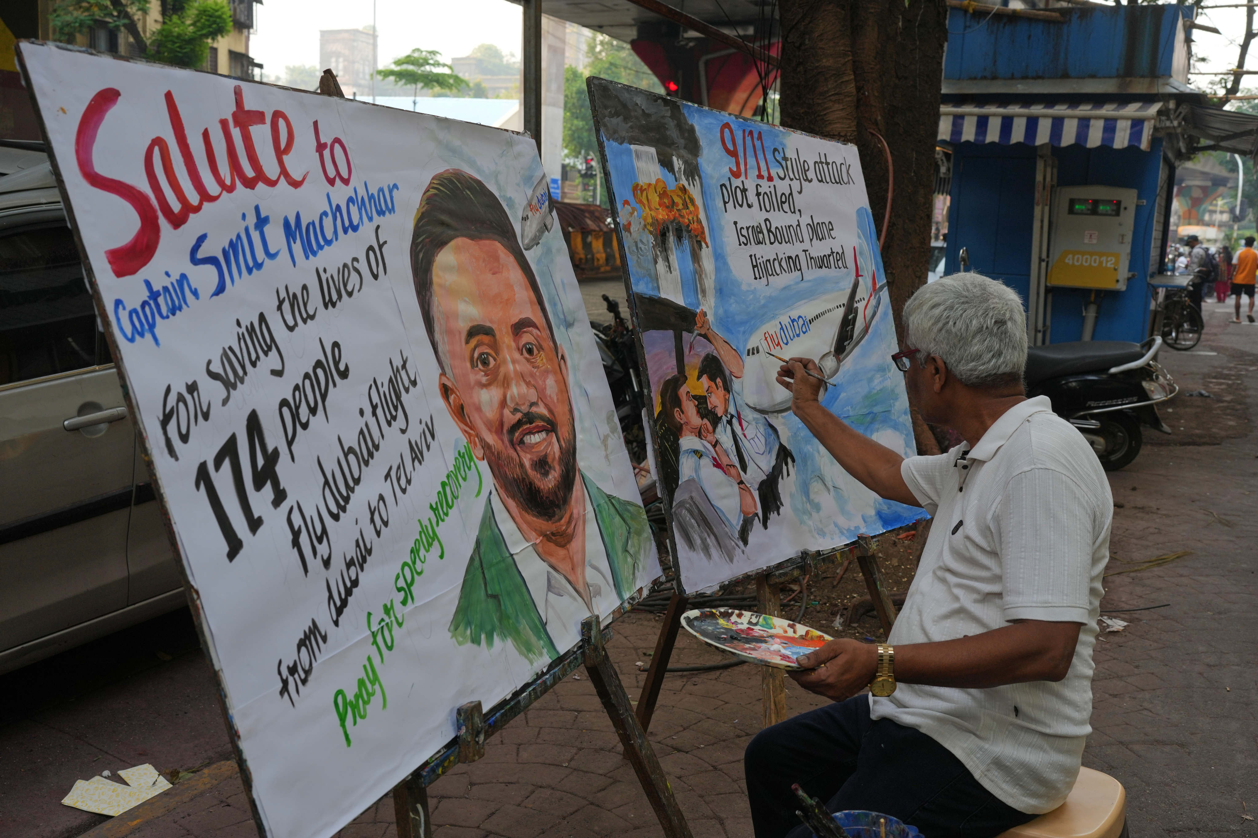 An art teacher in Mumbai paints a portrait honouring pilot Smit Machchhar on Thursday. Photo: AP