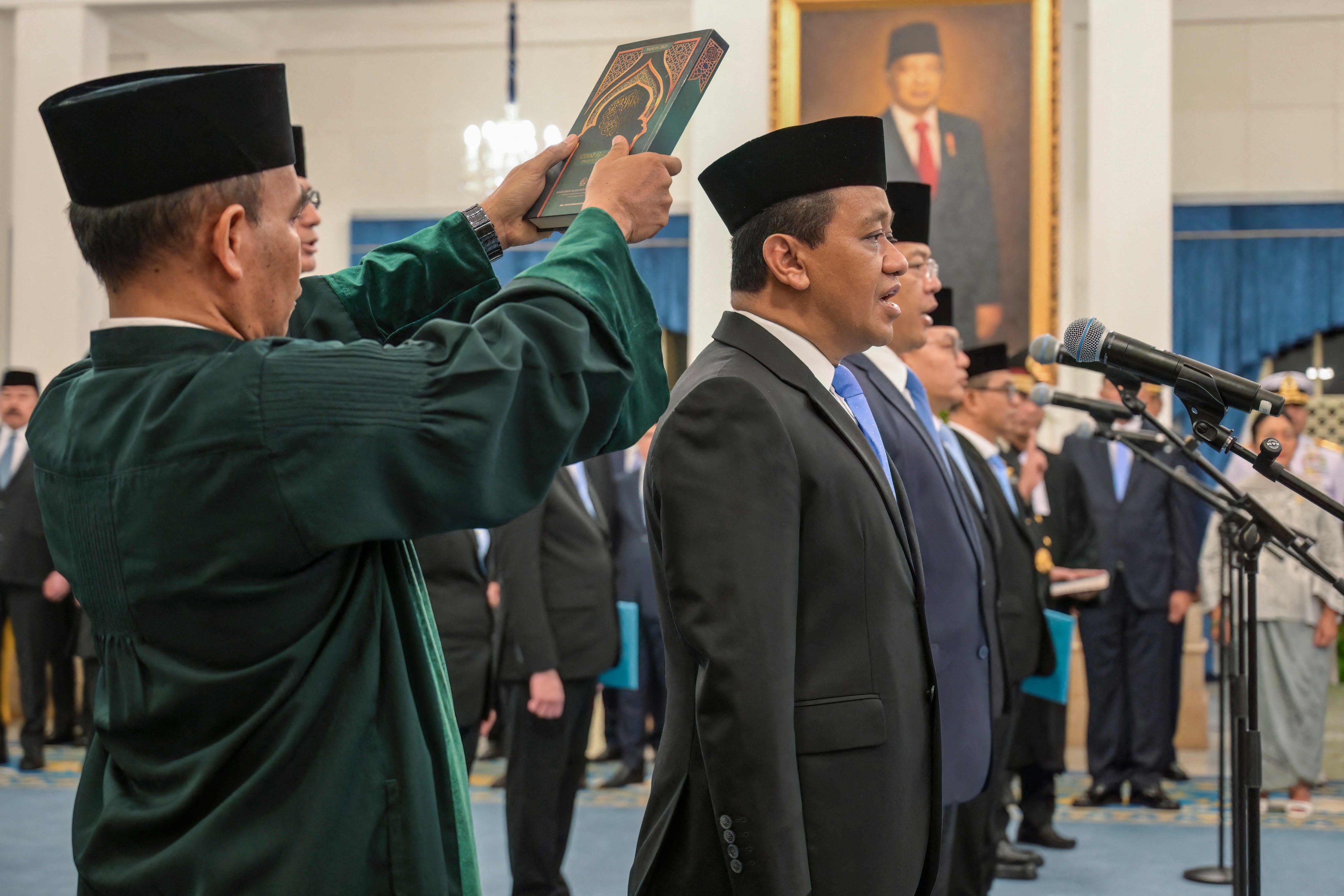 Newly appointed cabinet ministers take their oath of office during a swearing-in ceremony led by President Prabowo Subianto at the State Palace in Jakarta on Thursday. Photo: AFP