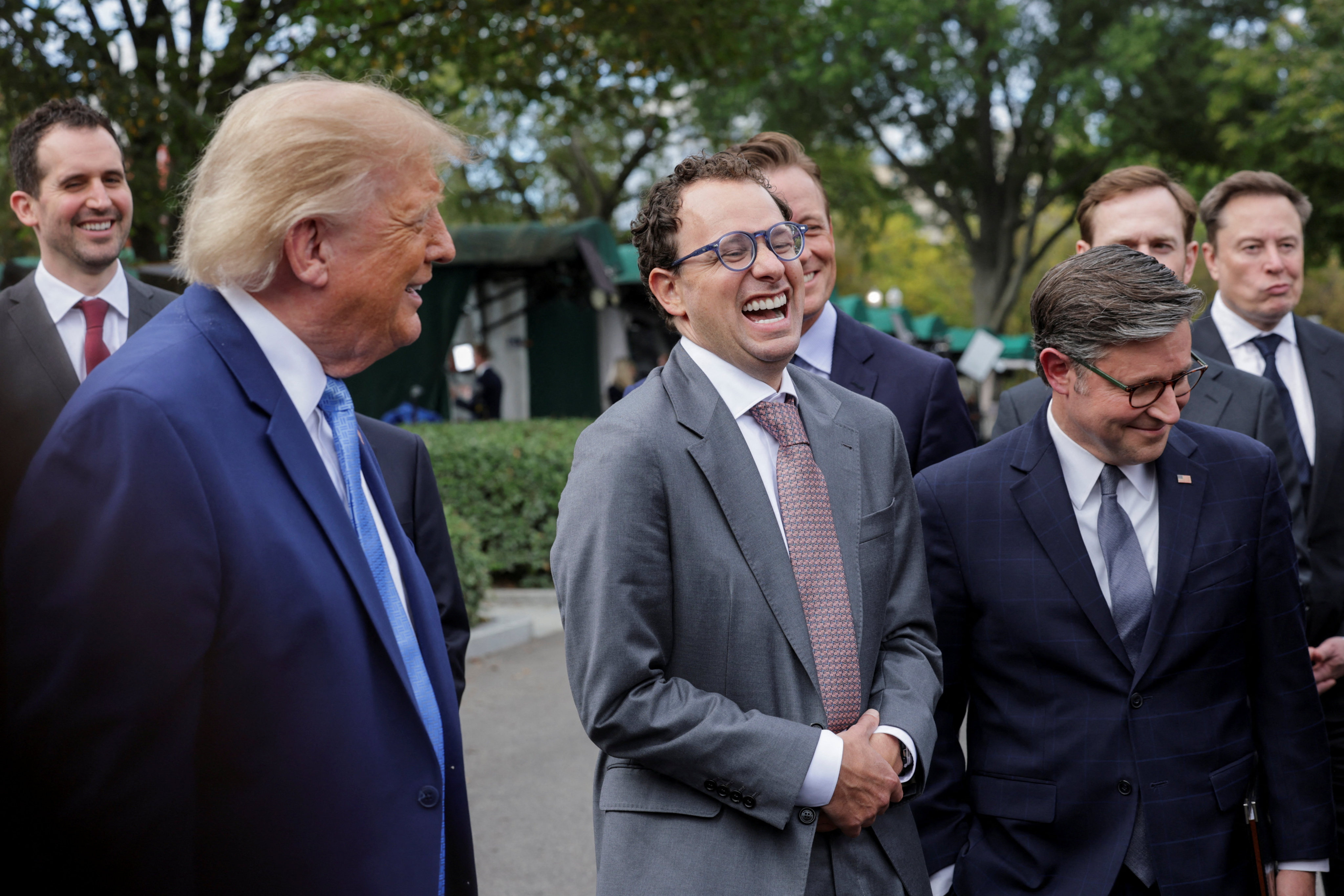Anthropic CEO Dario Amodei (centre) enjoys a light moment with US President Donald Trump (left) and House Speaker Mike Johnson as they speak to the media at the White House driveway following a luncheon for tech leaders in the East Room in Washington on September 29. Photo: Reuters