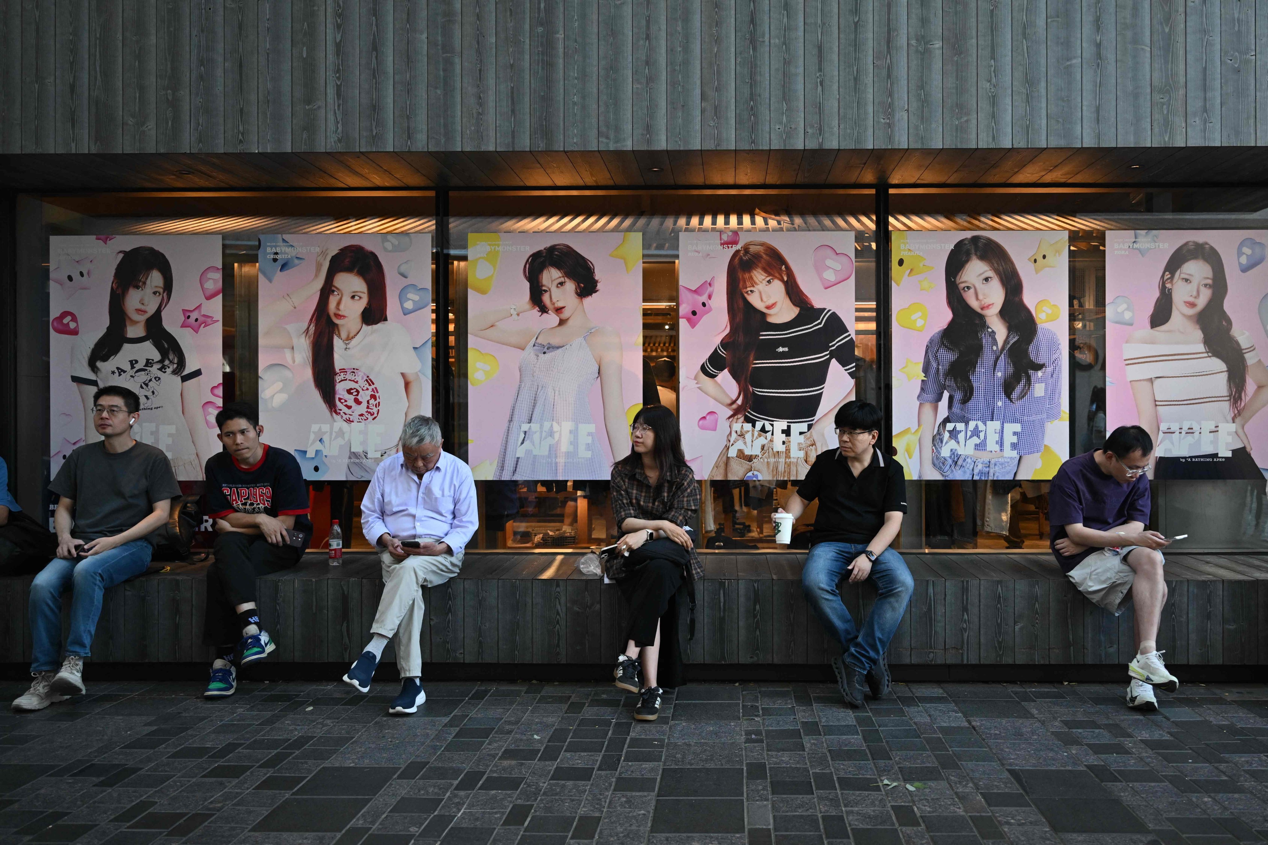 People sit around a shopping mall in Beijing on September 13. Photo: AFP