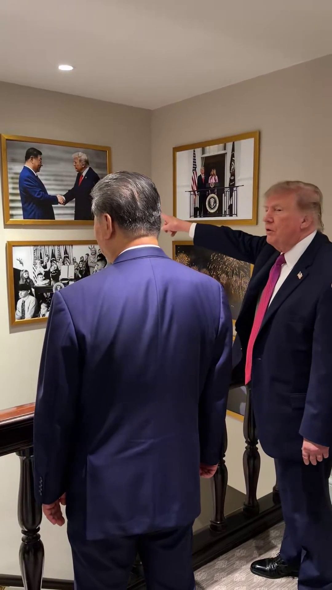 US President Donald Trump points out a framed photograph of the two leaders shaking hands on the wall of the White House in Washington to Chinese President Xi Jinping. Photo: Handout