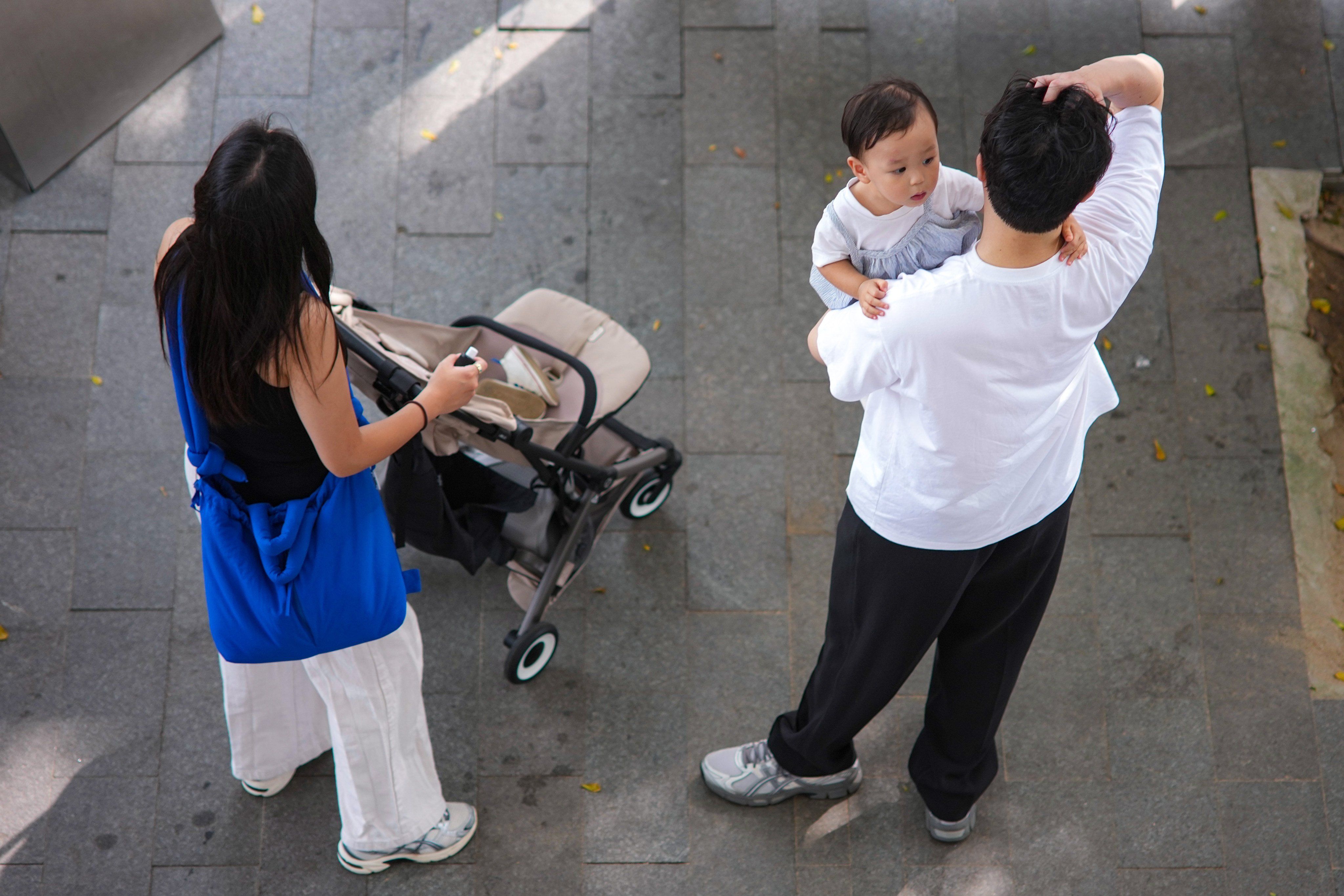 A couple look after their child in Central on September 22. In the first eight months of this year, Hong Kong recorded only 19,255 births, a 10 per cent drop compared with the same period in 2025. Photo: Karma Lo