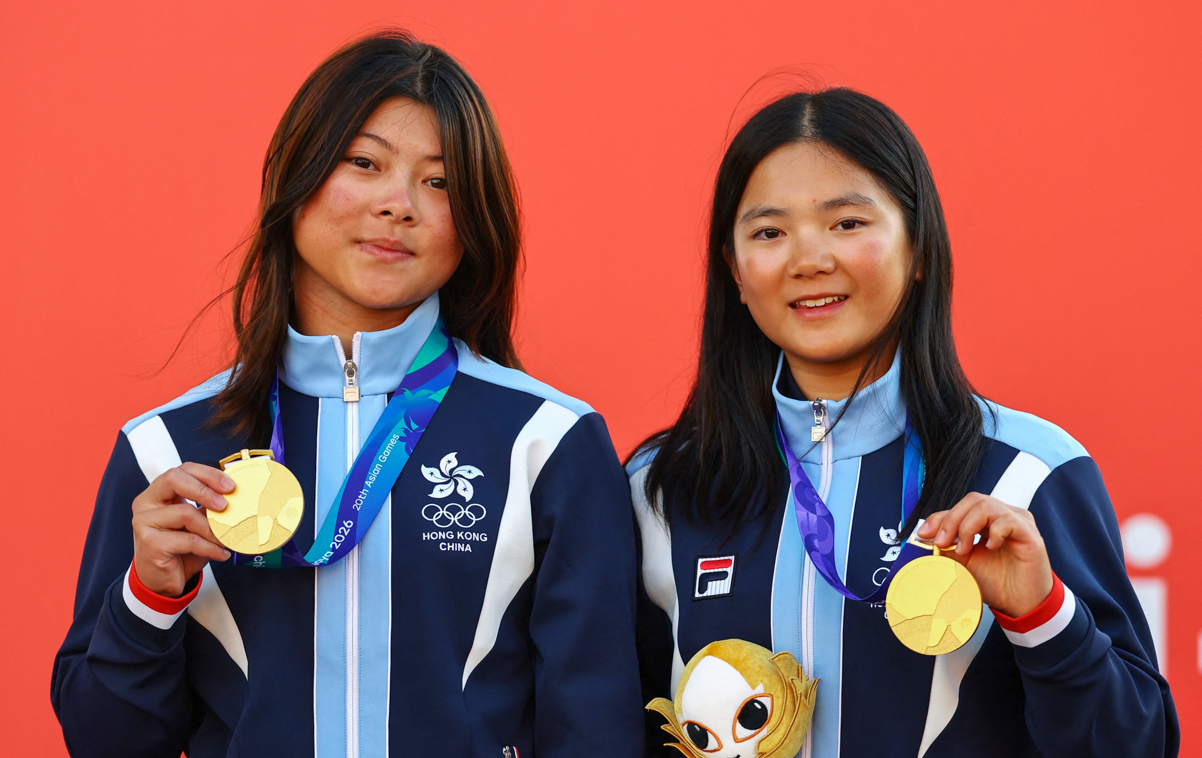 Hong Kong’s McCarley Wong (left) and Chloe Kong secured gold in the girls’ skiff event at the Asian Games. Photo: Reuters