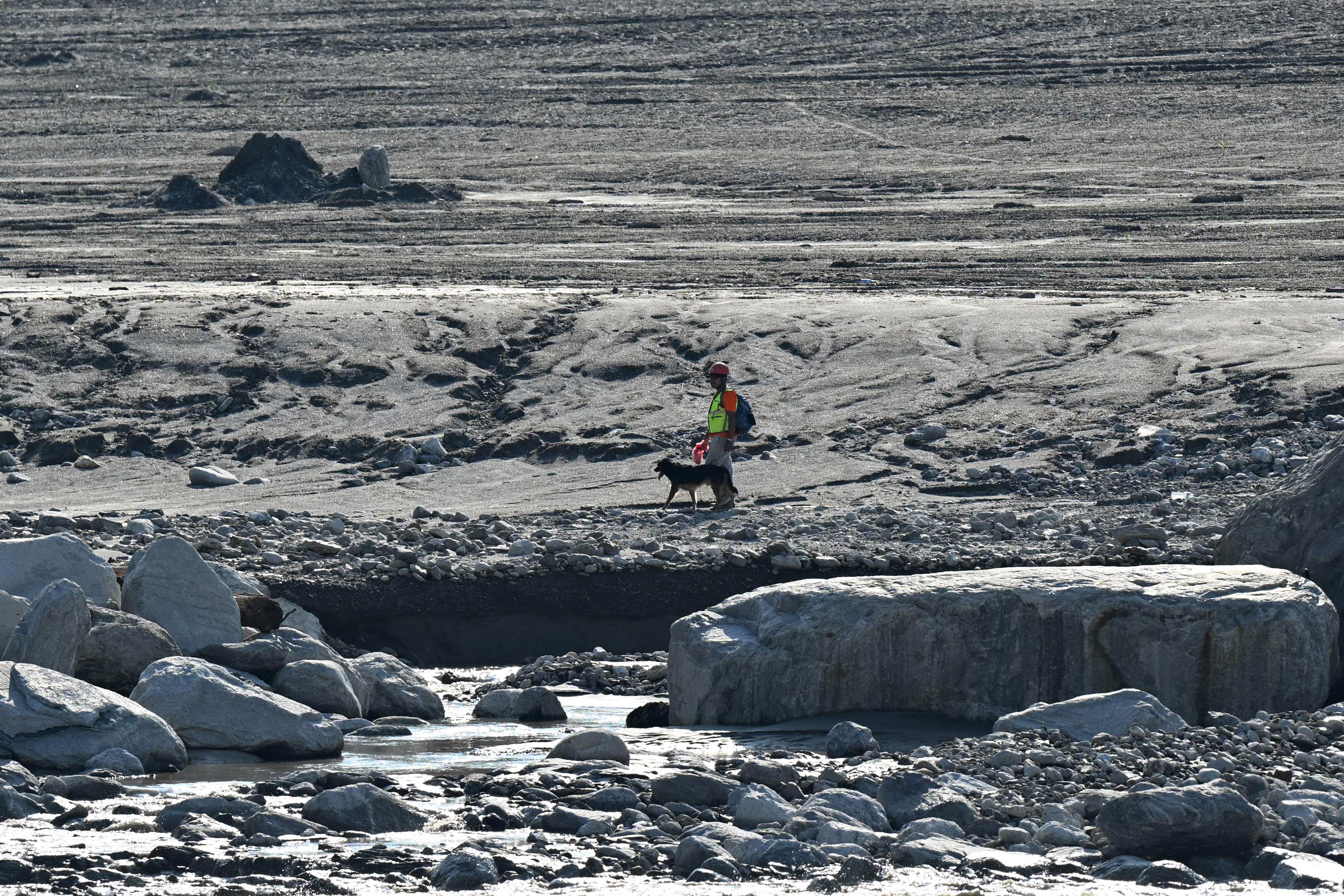 A rescuer looks for people missing in the Nepal floods on the banks of the Trishuli River in Rasuwa district on Monday. Photo: AFP