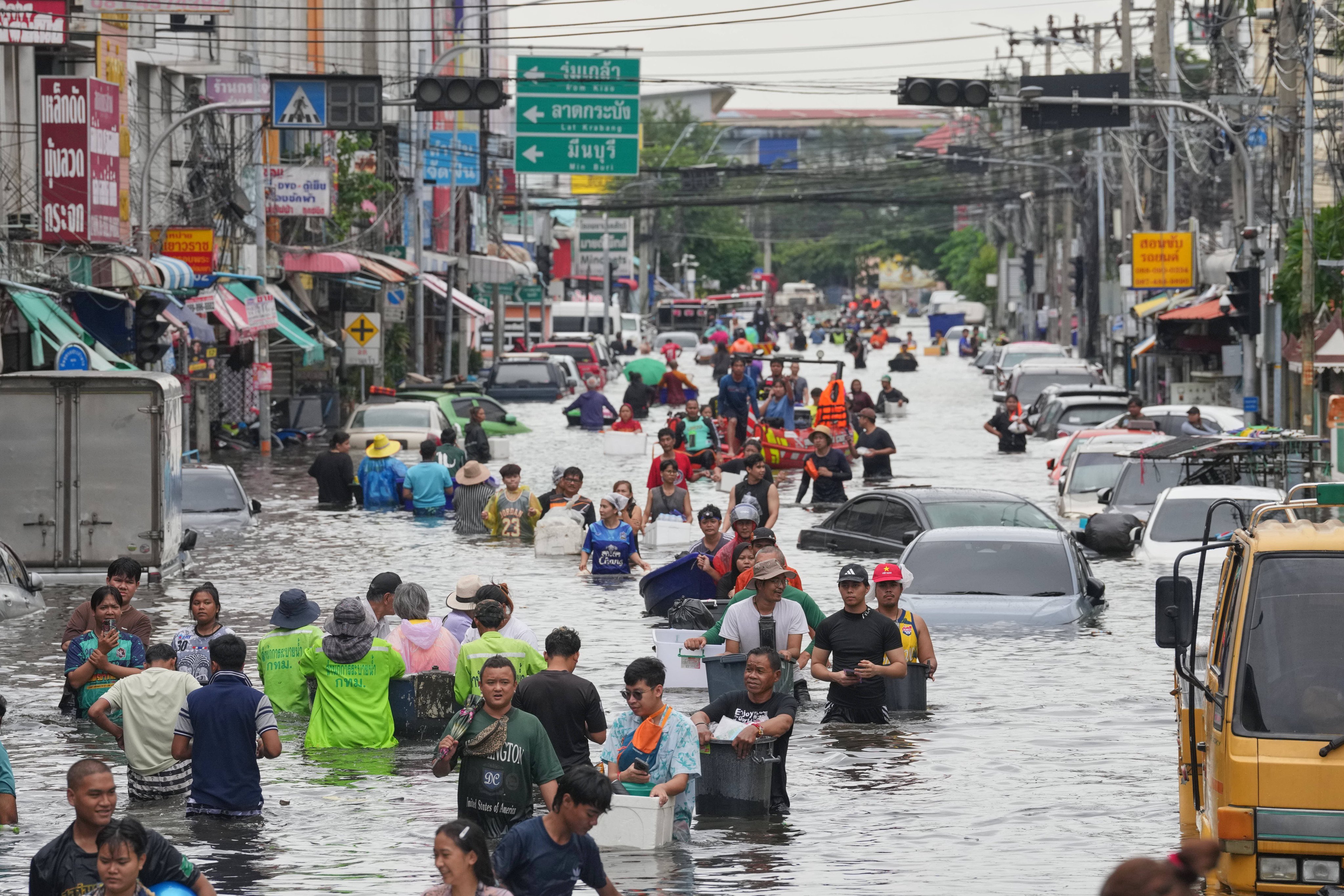 People wade through a flooded street after heavy rain in Bangkok, Thailand, on September 28. Photo: AP