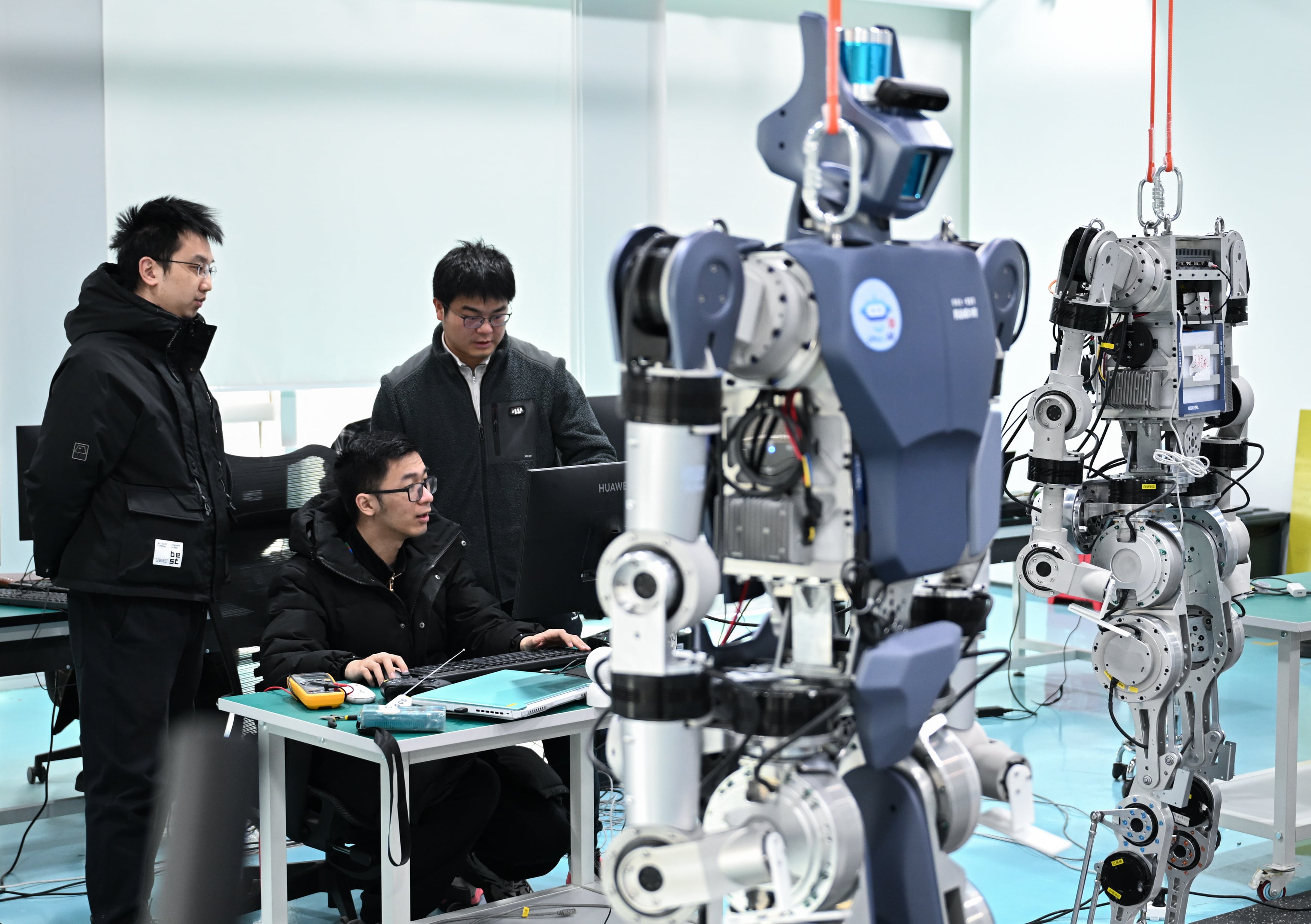 Members of the R&D team of Wuhan Glory Road Intelligent Technology Co Ltd debug humanoid robots at the company premises in Wuhan, central China’s Hubei Province, on February 24, 2025. China’s spending on R&D reached a record 2.8 per cent of GDP last year. Photo: Xinhua