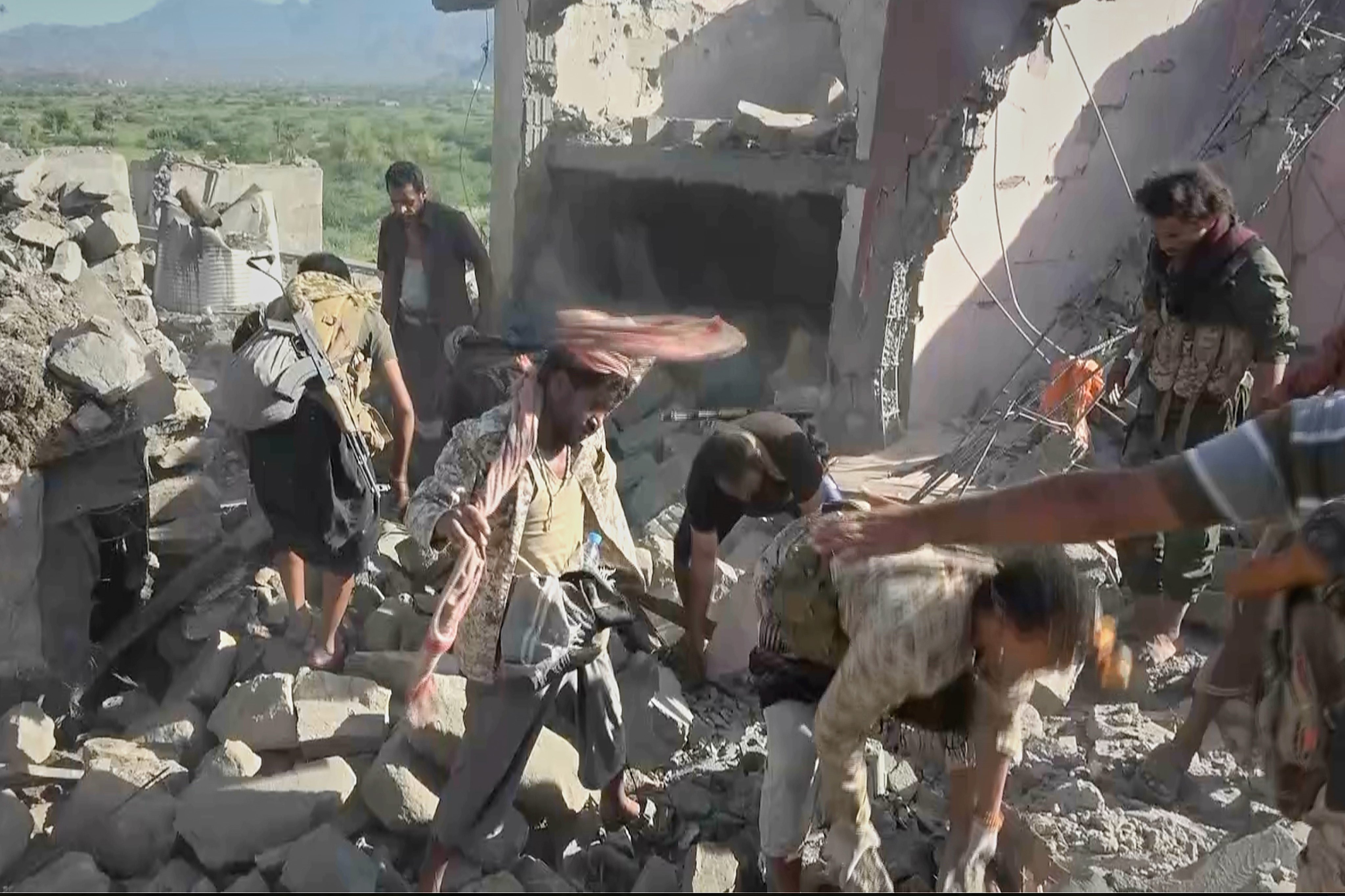 Houthi fighters and local residents search through the rubble of a house following a strike by Saudi-backed forces in the town of Kadhah, in Taiz province, Yemen last month. Photo: Al-Masirah TV/AP