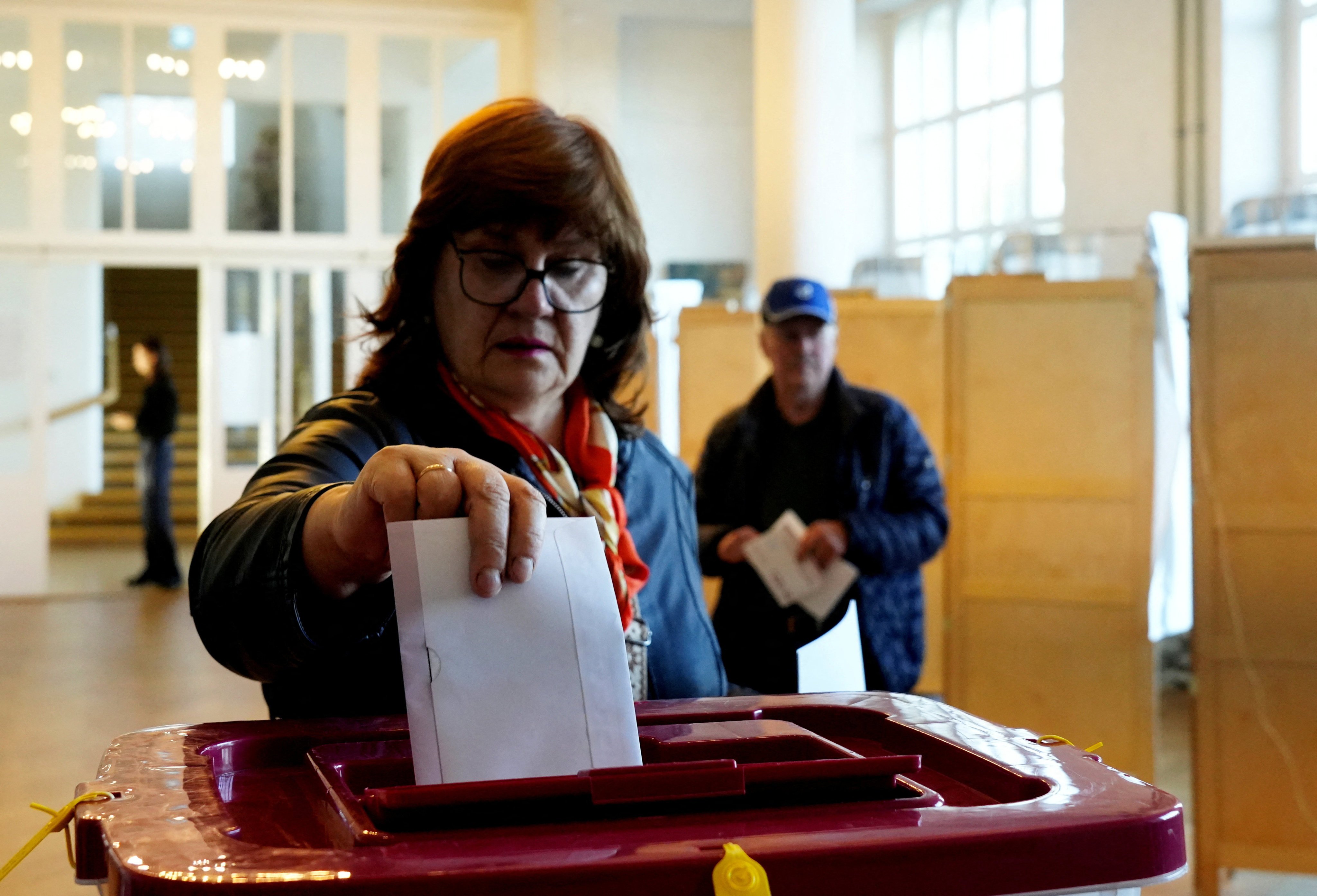 A woman votes during the general election in Saulkrasti, Latvia on Saturday. Photo: Reuters