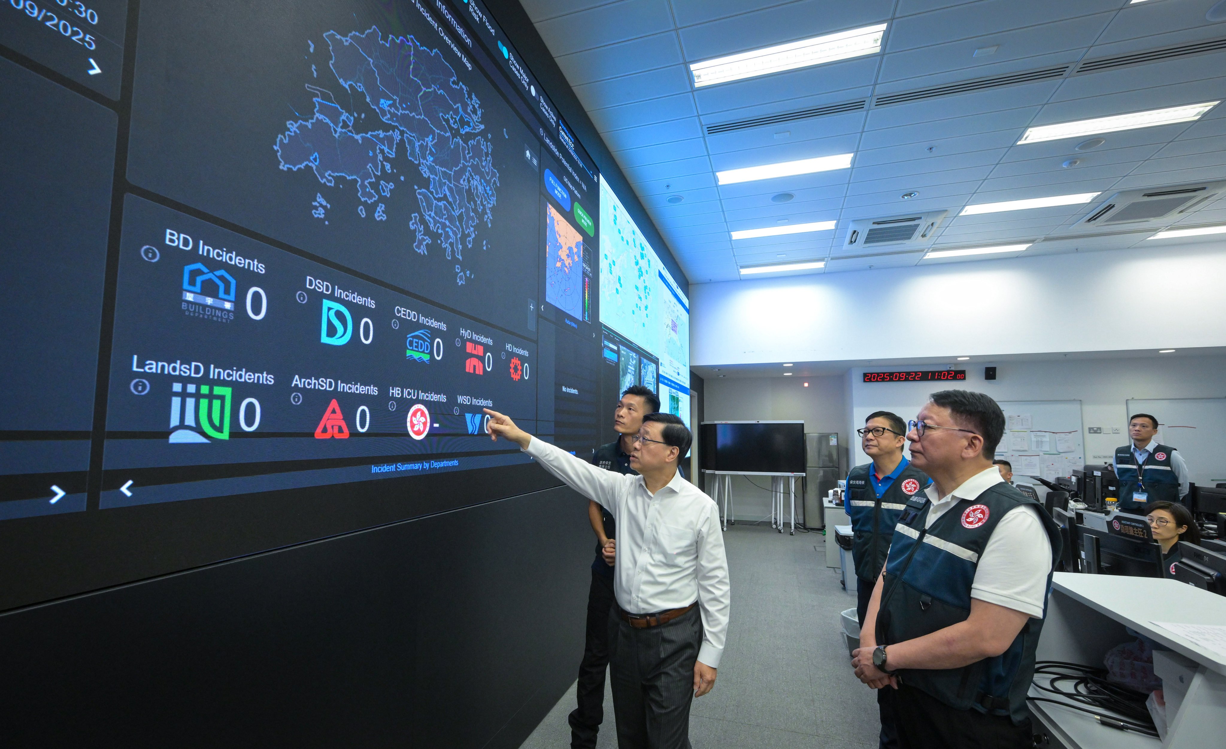 Chief Executive John Lee (left) inspects the operation of the Security Bureau’s Emergency Monitoring and Support Centre. Also pictured are Chief Secretary Eric Chan (first right) and Secretary for Security Chris Tang (second right). Photo: Handout