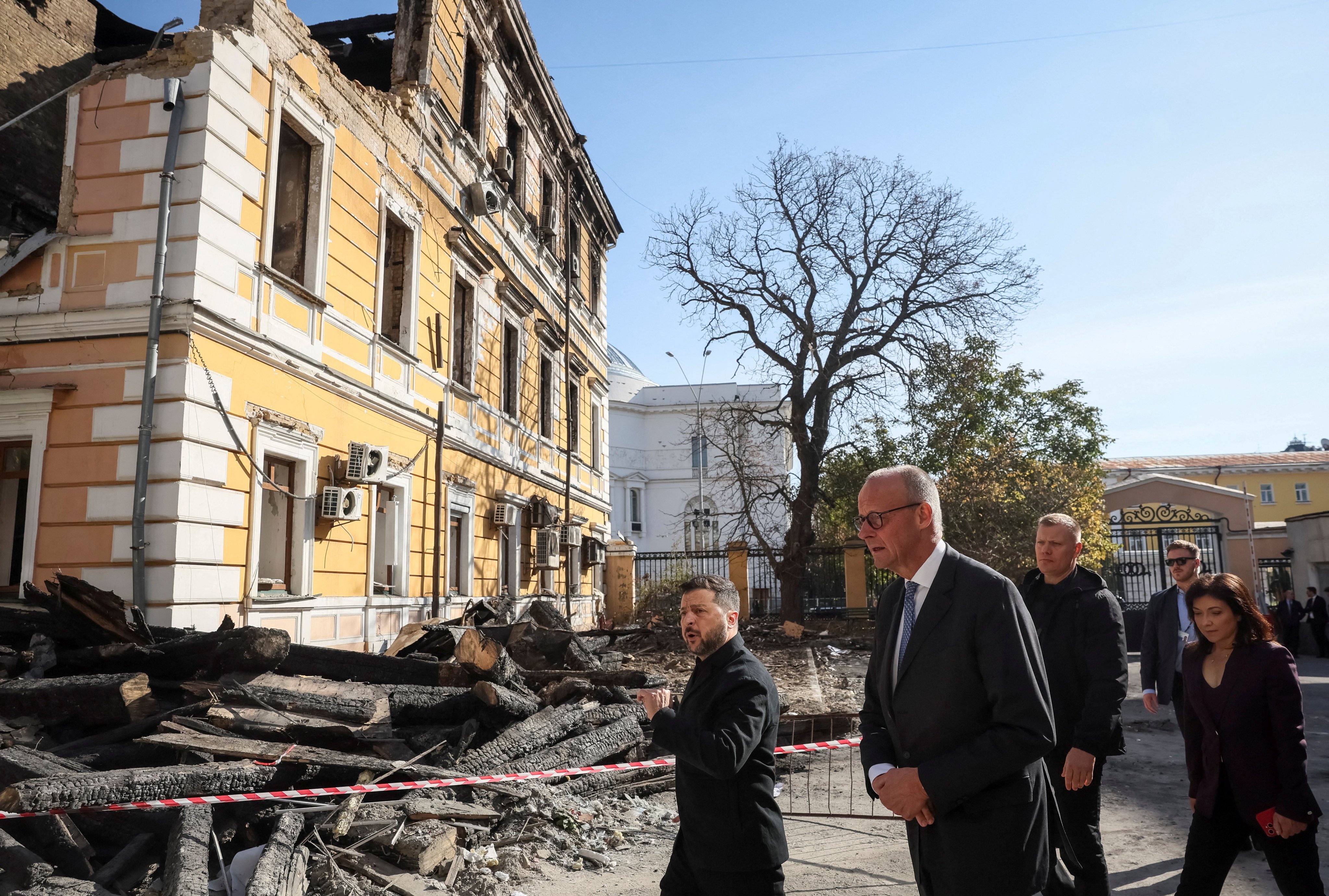 Ukraine’s President Volodymyr Zelensky (centre), German Chancellor Friedrich Merz (centre-right) and German Energy Minister Katherina Reiche (right) visit the site of an administrative building of Ukraine’s National Academy of Sciences hit during recent Russian drone strikes, amid Russia’s invasion of Ukraine, in Kyiv on Sunday. Photo: Reuters