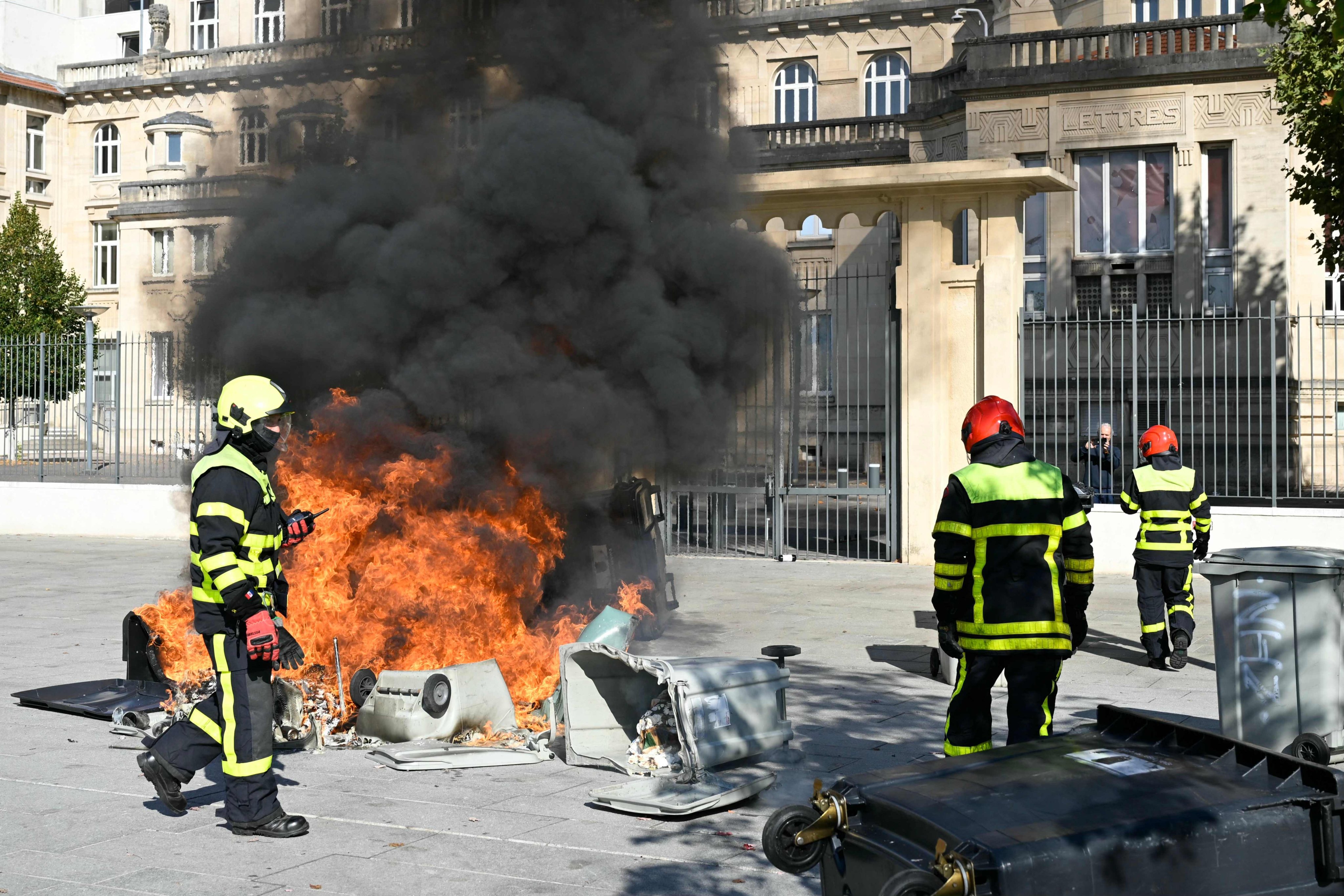 Firefighters arrive to extinguish a fire in front of Jean-Louis Cyffle high school on the sidelines of a demonstration of high school students in Nancy, France, on Monday. Photo: AFP