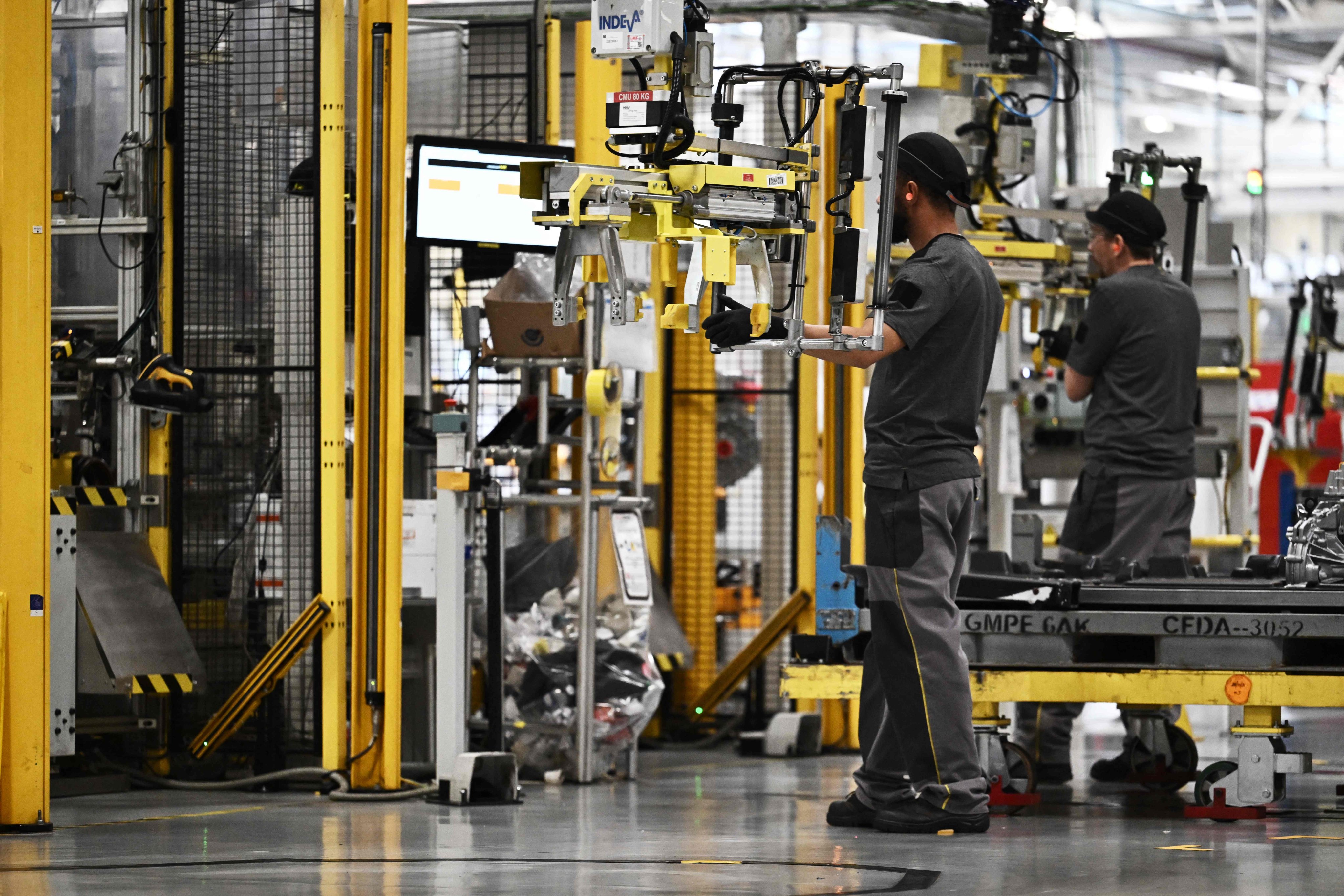 Employees work on equipment for electric cars at a Renault factory in Cleon, northwestern France on October 2, 2026. Photo: AFP