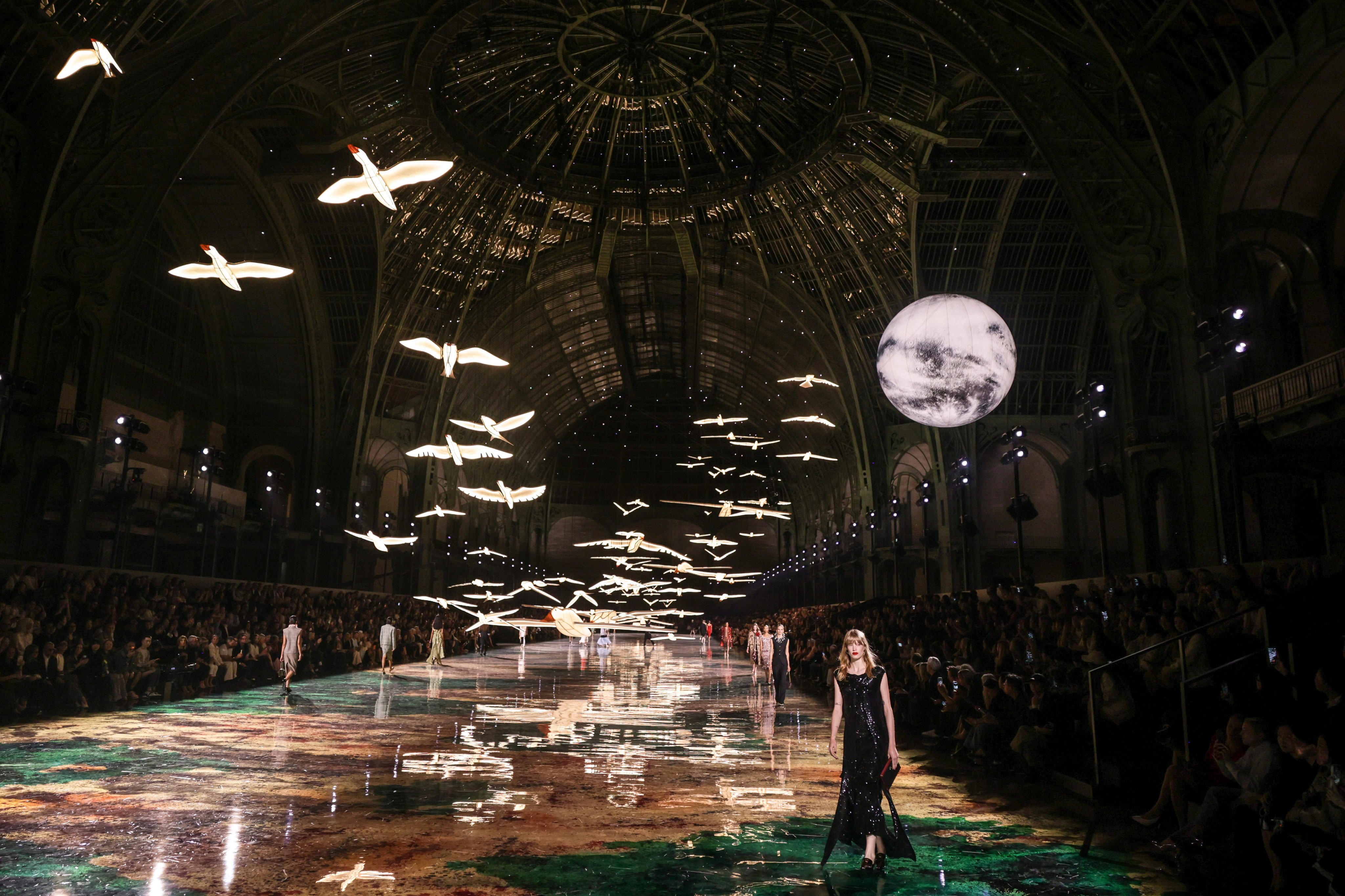 The set of Chanel’s spring/summer 2027 show featured a moon and birds flying above the runway. Photo: AP Photo