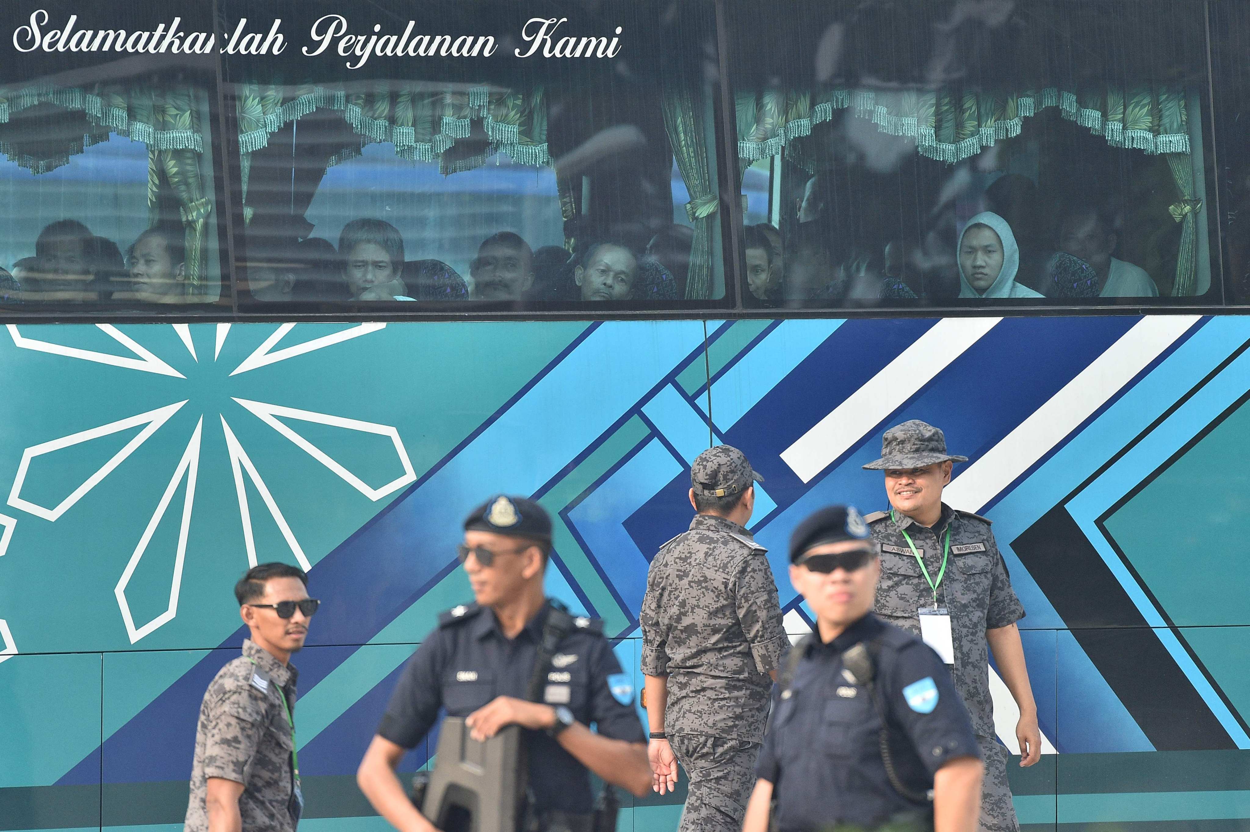 A bus carrying Myanmar nationals being repatriated from Malaysia to their homeland is seen heading towards a naval base in Lumut, Malaysia, last month. Photo: AFP
