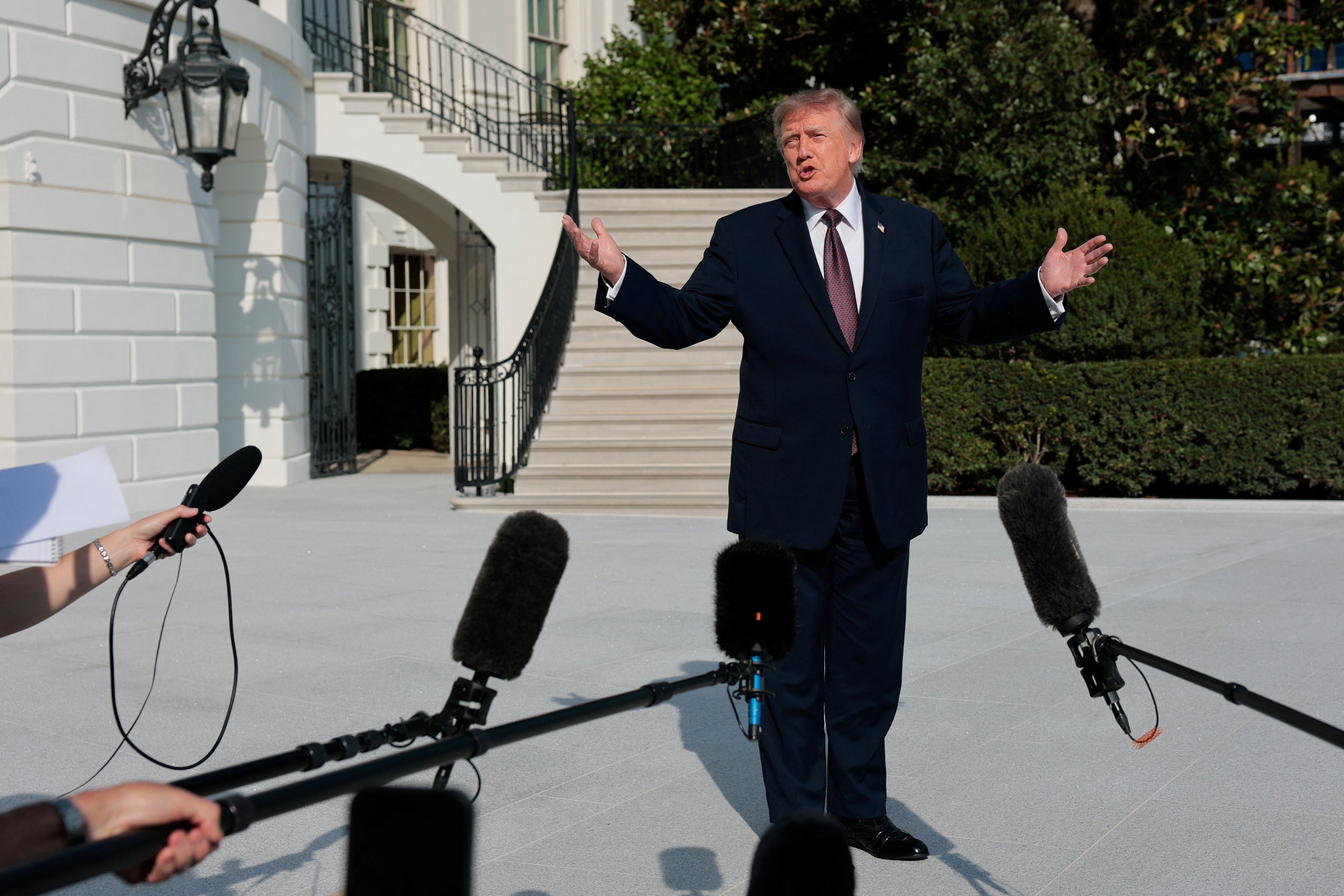 US President Donald Trump speaks with reporters on the South Lawn of the White House. Photo: Reuters