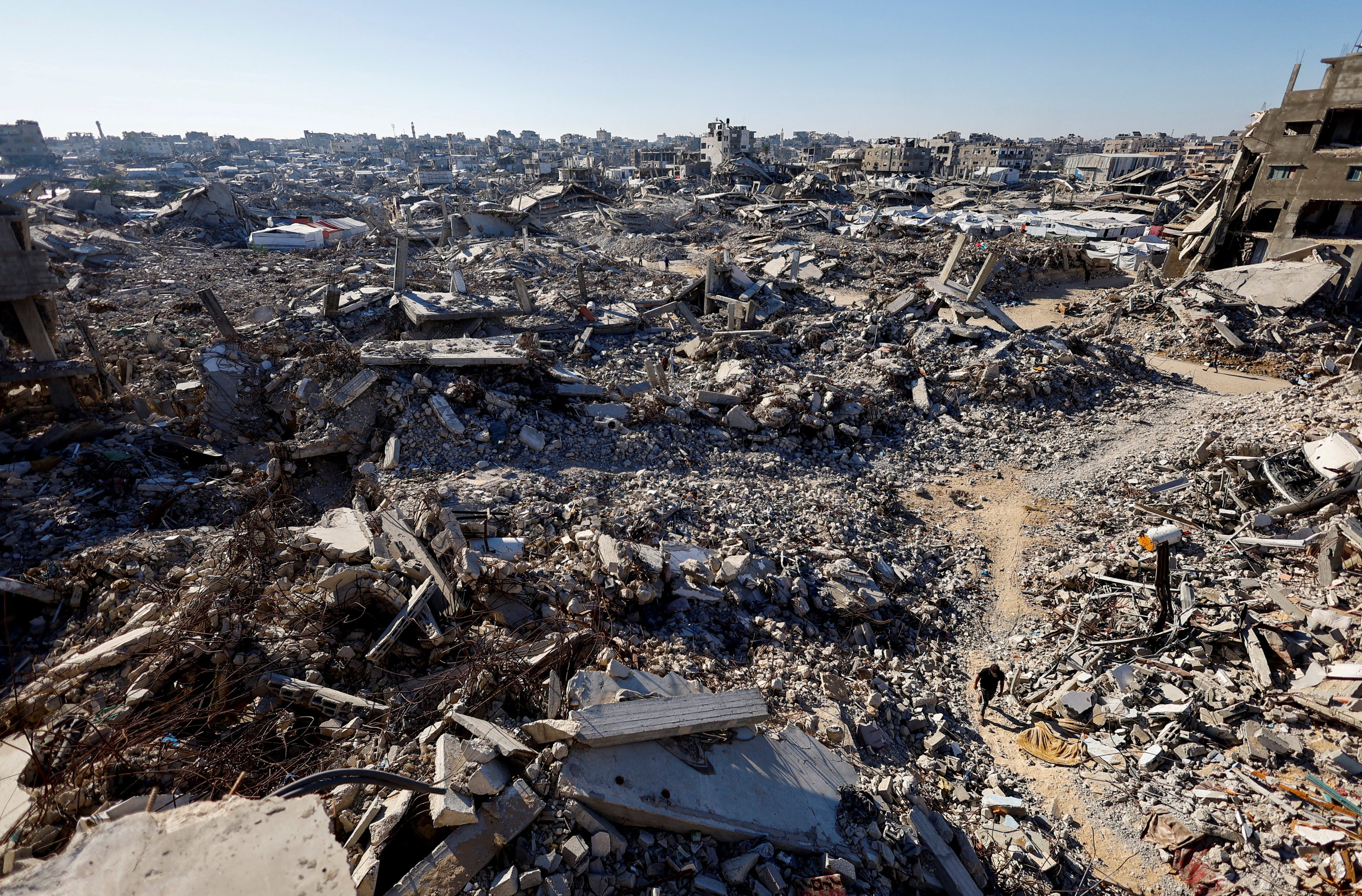 A Palestinian walks amid the rubble in Gaza City. Photo: Reuters