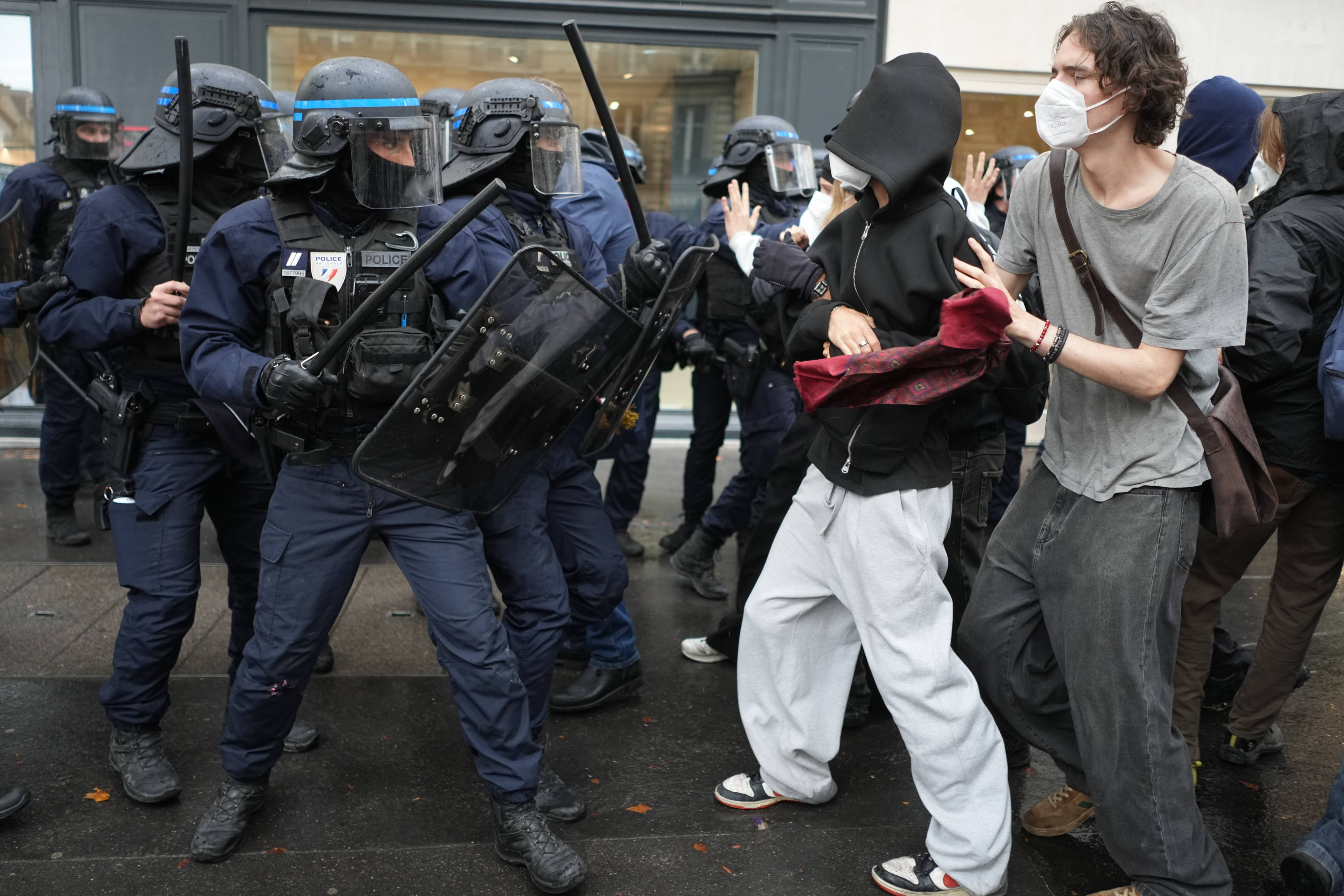 Police officers face students in front of Sciences Po university as they protest against under-resourced schools, in Paris, France, on Wednesday. Photo: AP