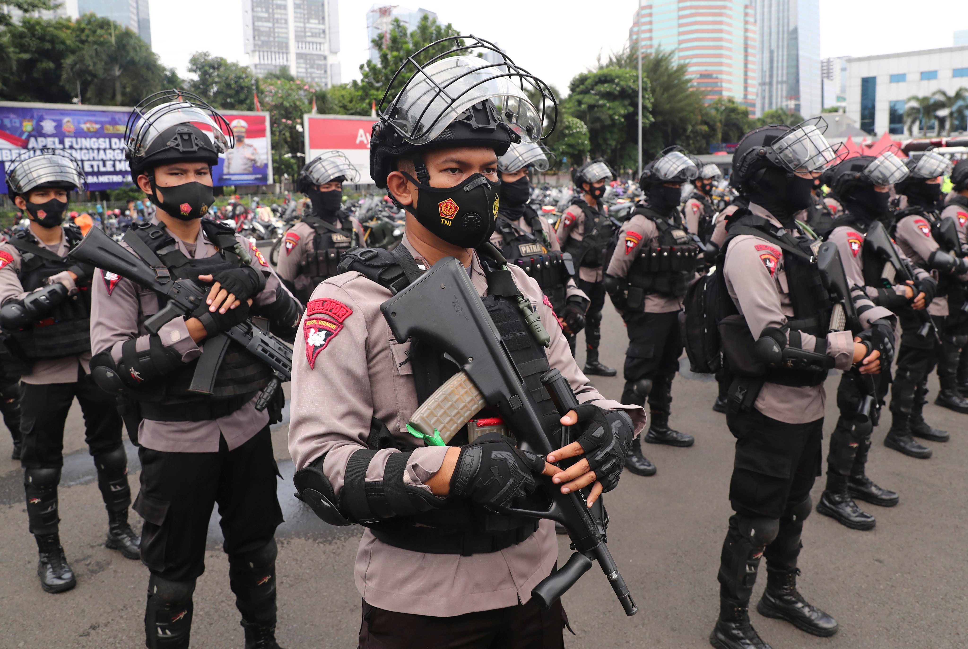 Police officers stand in attention at the regional police headquarters in Jakarta in 2021. Photo: AP