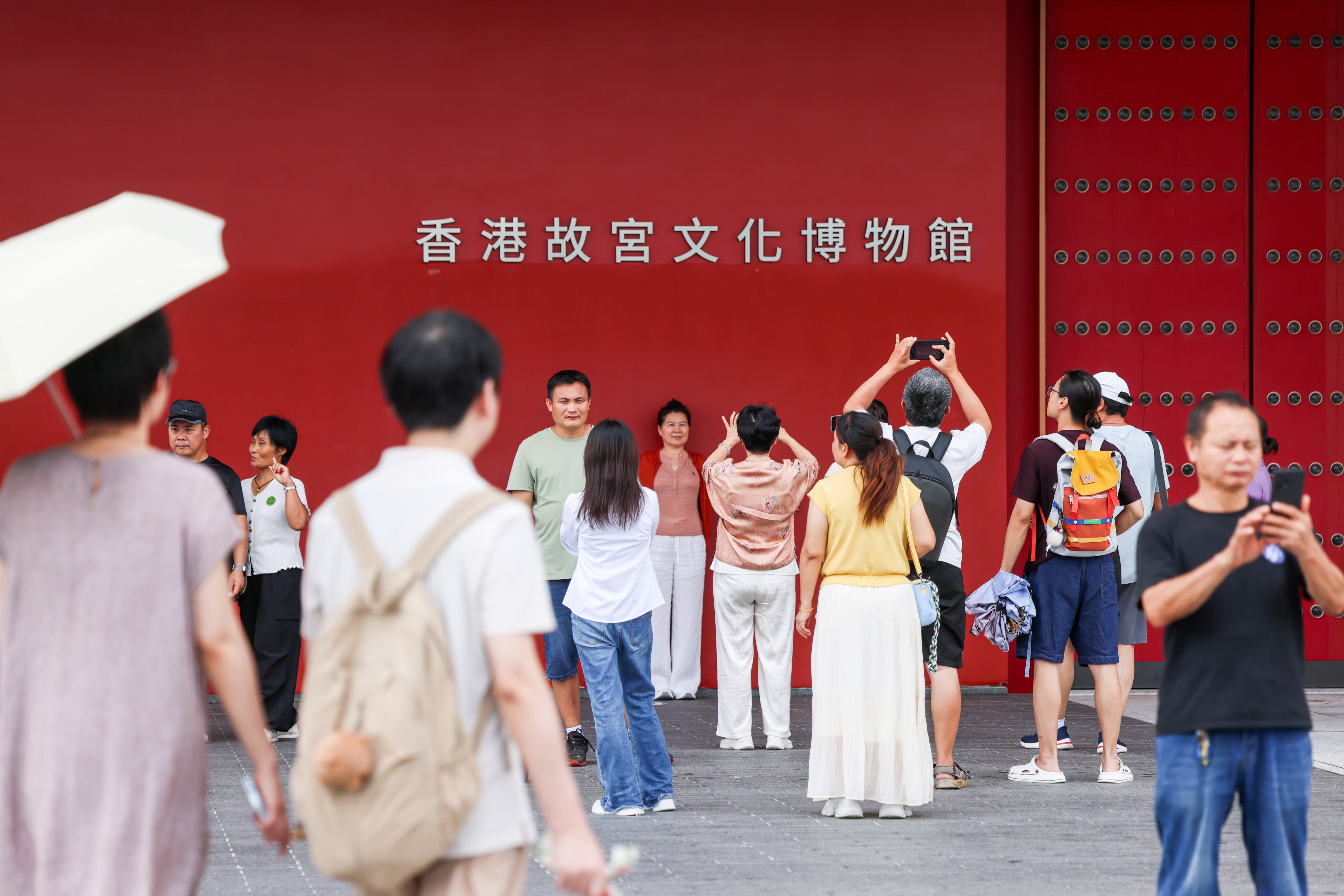 Visitors pose for photos in front of the Hong Kong Palace Museum in the West Kowloon Cultural District. Photo: Silvia Siu
