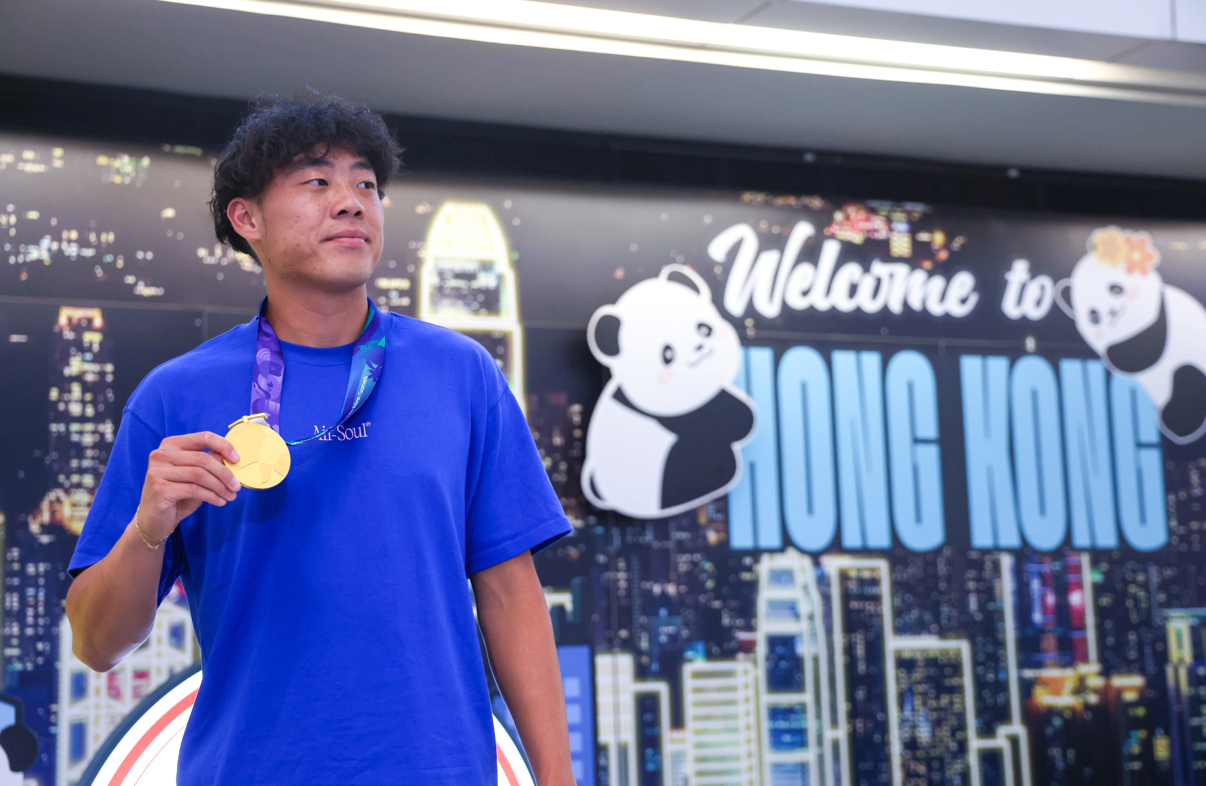 Hong Kong tennis star Coleman Wong at Hong Kong International Airport arrival hall with his Asian Games gold medal. Photo: Silvia Siu