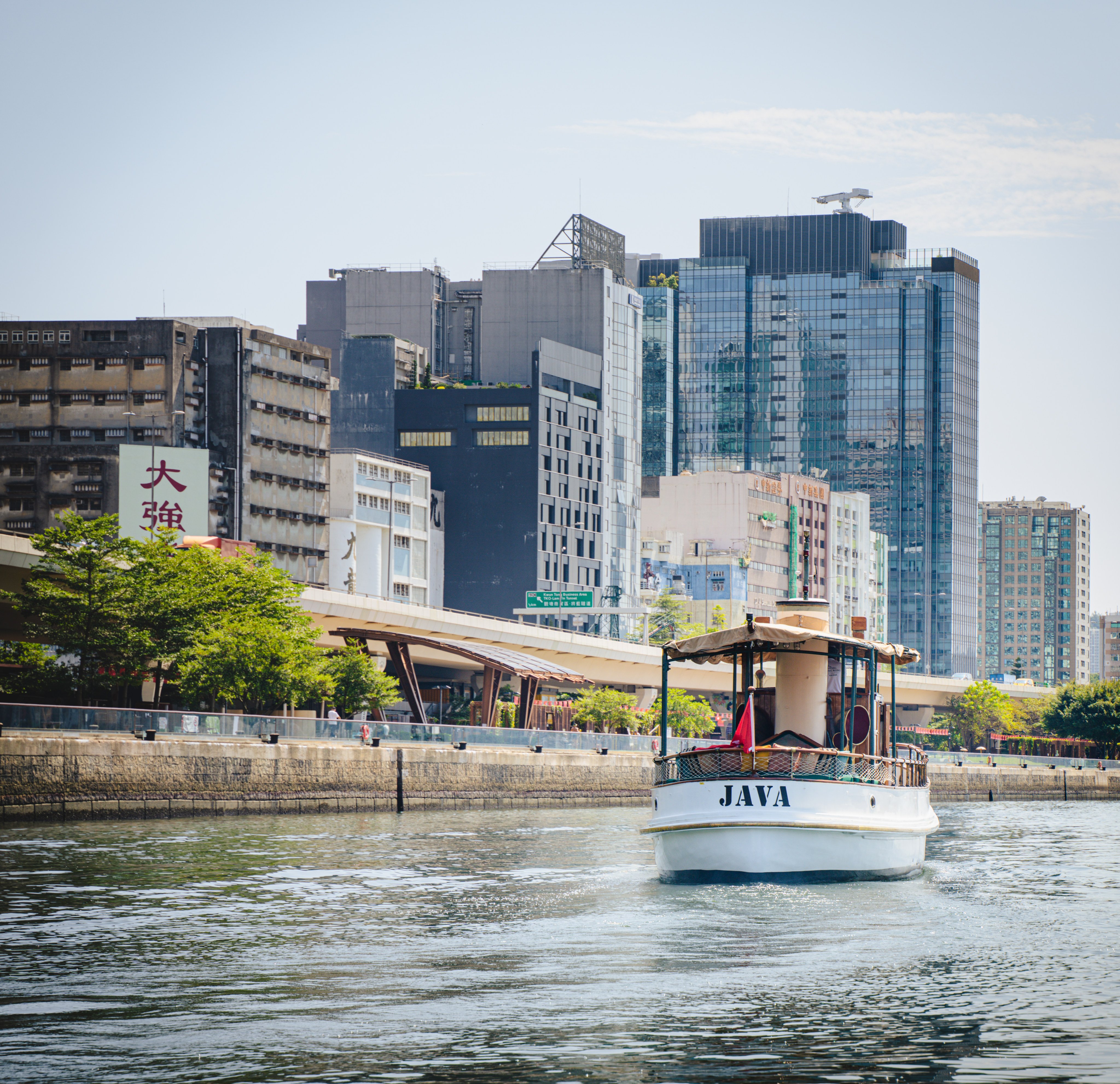 Java, a 1930s-era wooden vessel built by the Hong Kong and Whampoa Dock Company, sails by Hong Kong's Kwun Tong district. Photo: Alexander Mak