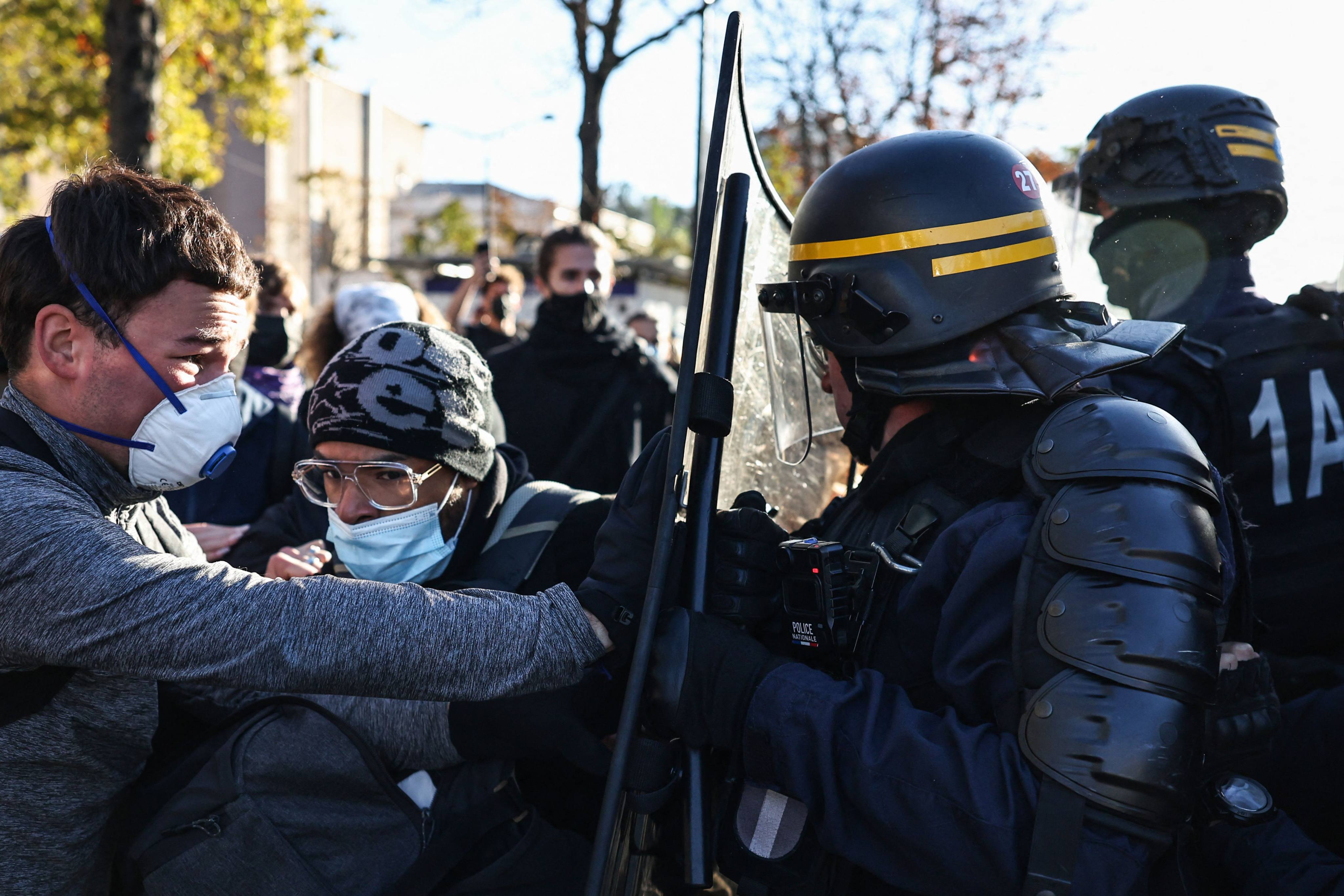 French Republican Security Corps police officers in riot gear (right) scuffle with protesters during a student demonstration near Helene Boucher high school in Paris on Thursday. Photo: AFP