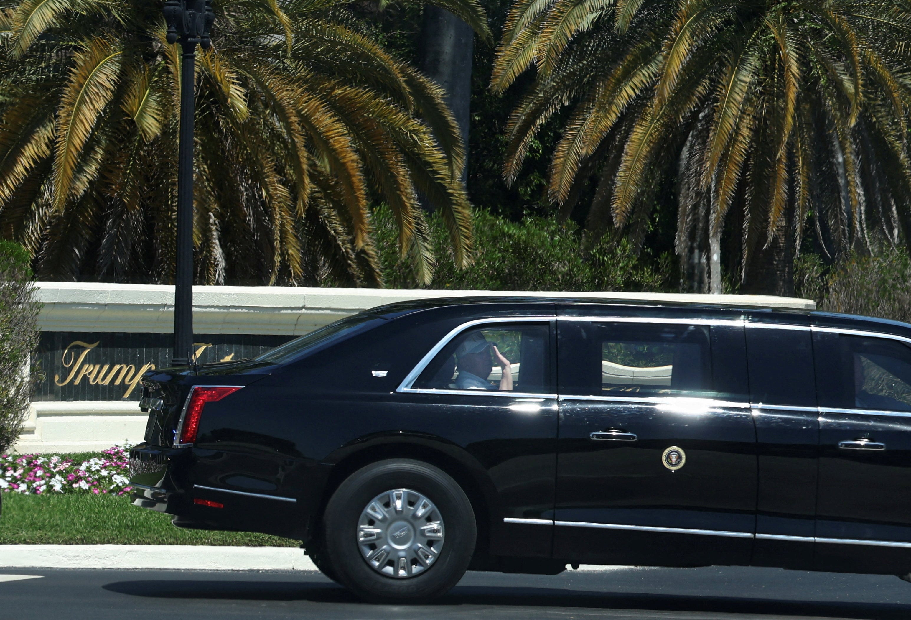 US President Donald Trump waves as he departs Trump International Golf Club in West Palm Beach, Florida. Photo: Reuters