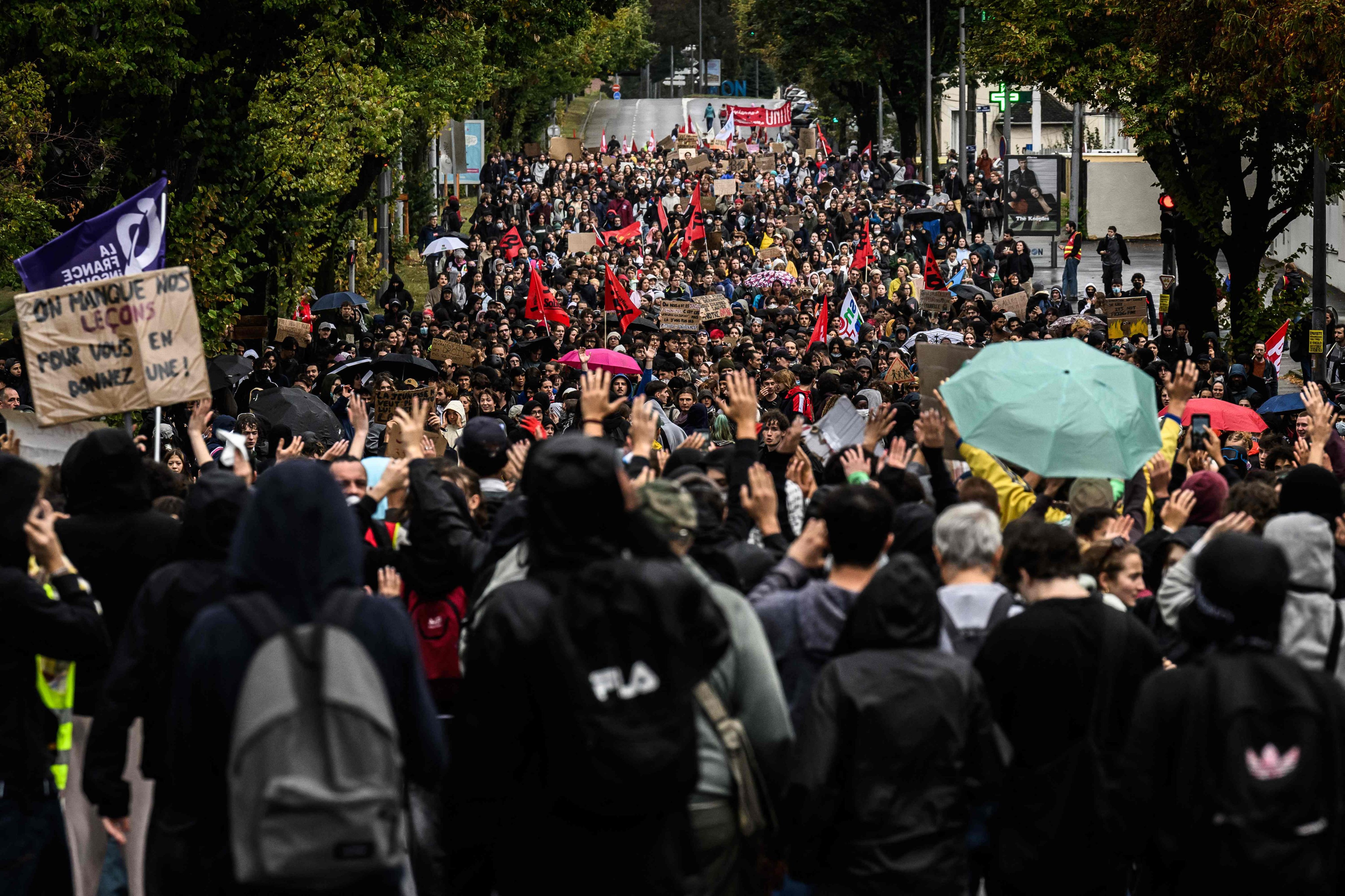 Protesters hold placards and banners during a demonstration of high school students in Bron, in the outskirts of Lyon, France, on Thursday. Photo: AFP