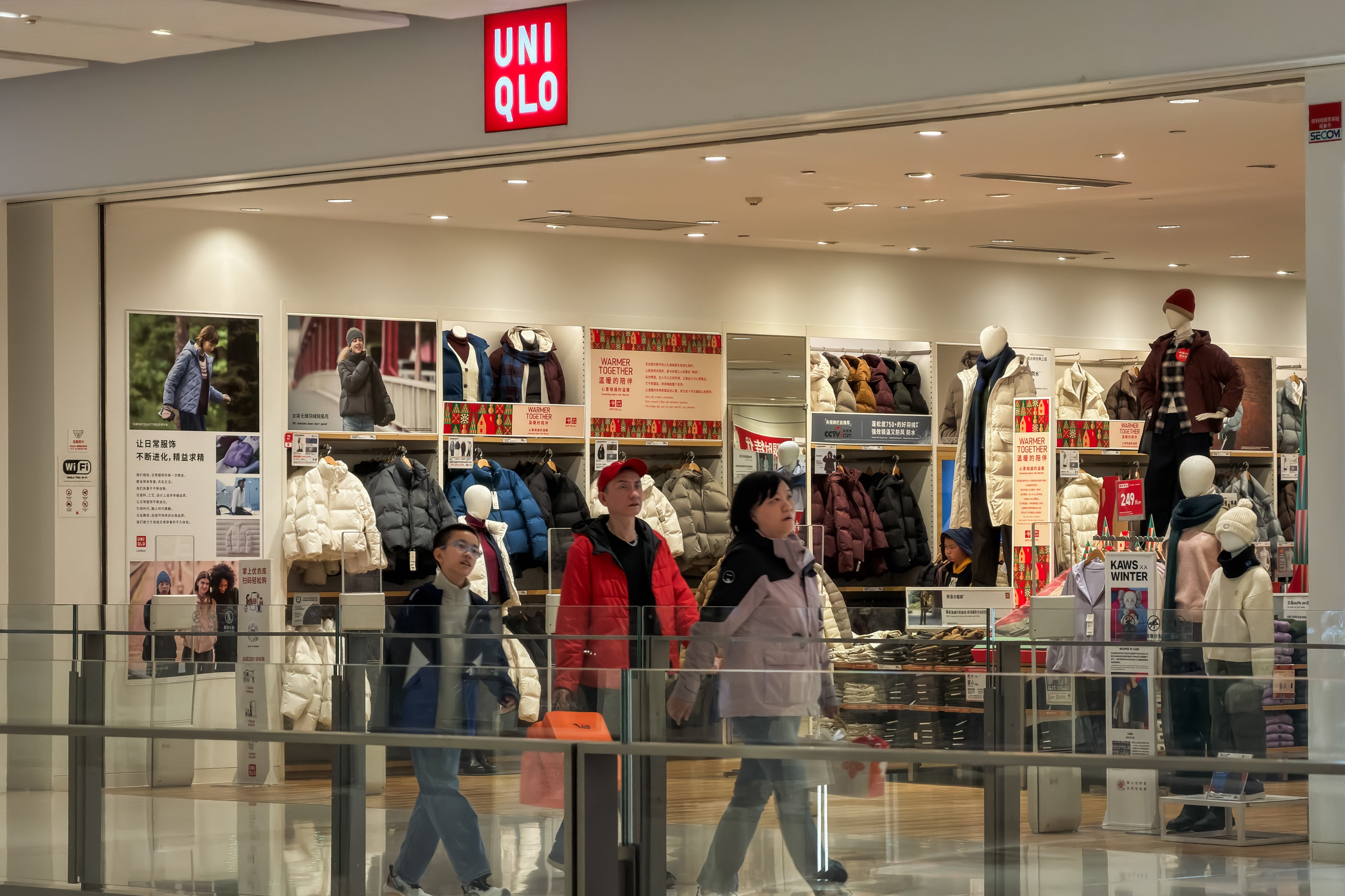 People walk past a Uniqlo retail store inside a commercial shopping mall in Chongqing, southwest China. Photo: Getty Images
