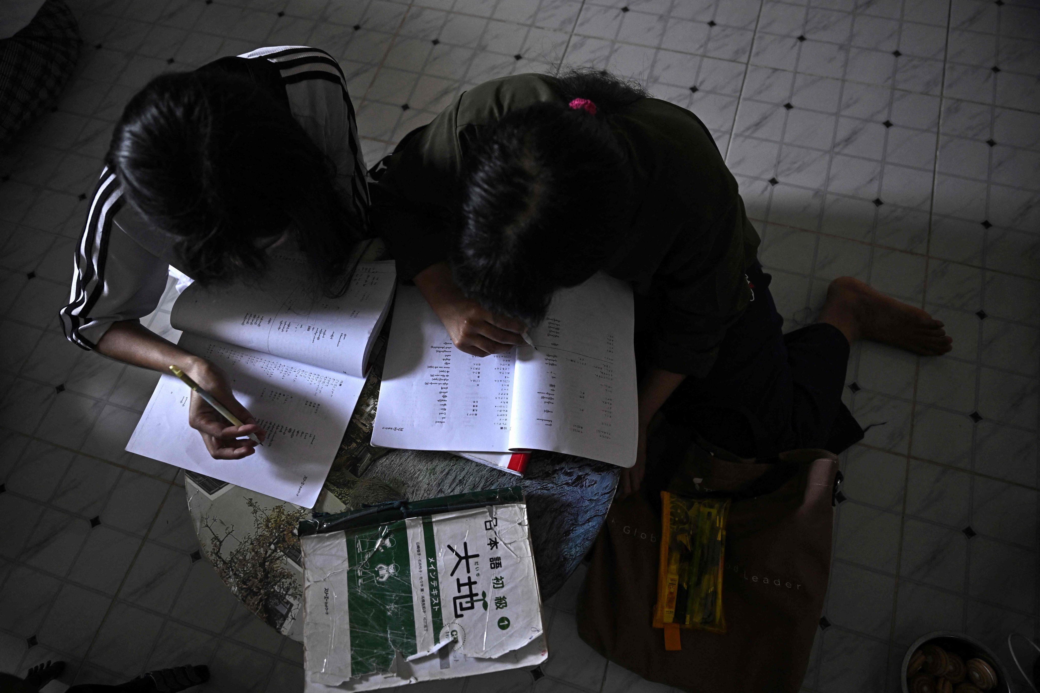 A Myanmar migrant worker studies inside a flat in Samut Sakhon province, Thailand, in January 2025. Photo: AFP